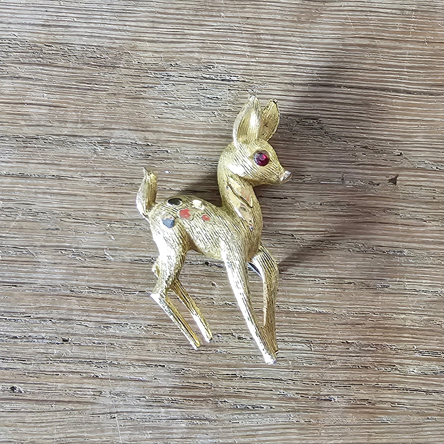 1950s gold-tone fawn brooch with red rhinestone eye
