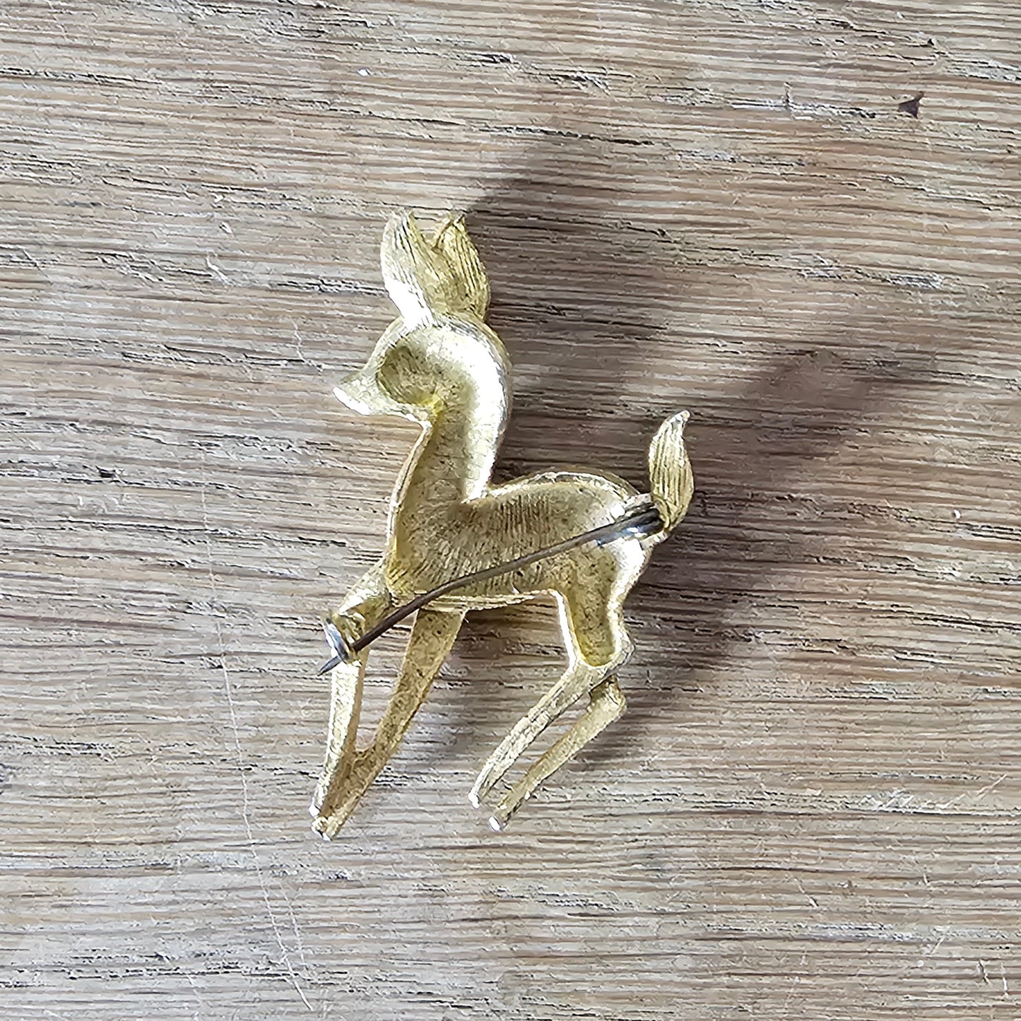 1950s gold-tone fawn brooch with red rhinestone eye