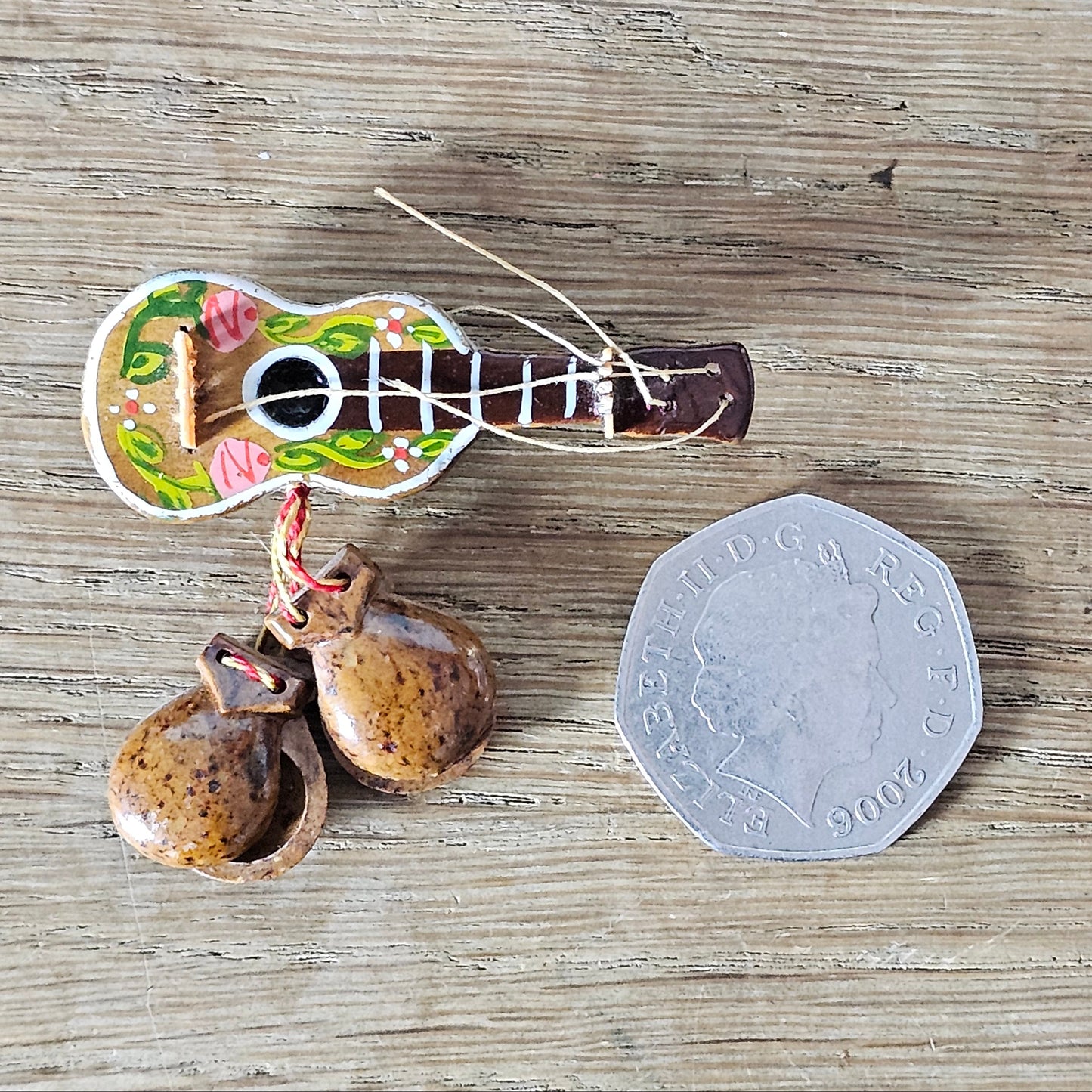 1940s hand-painted wooden guitar brooch with hanging maracas