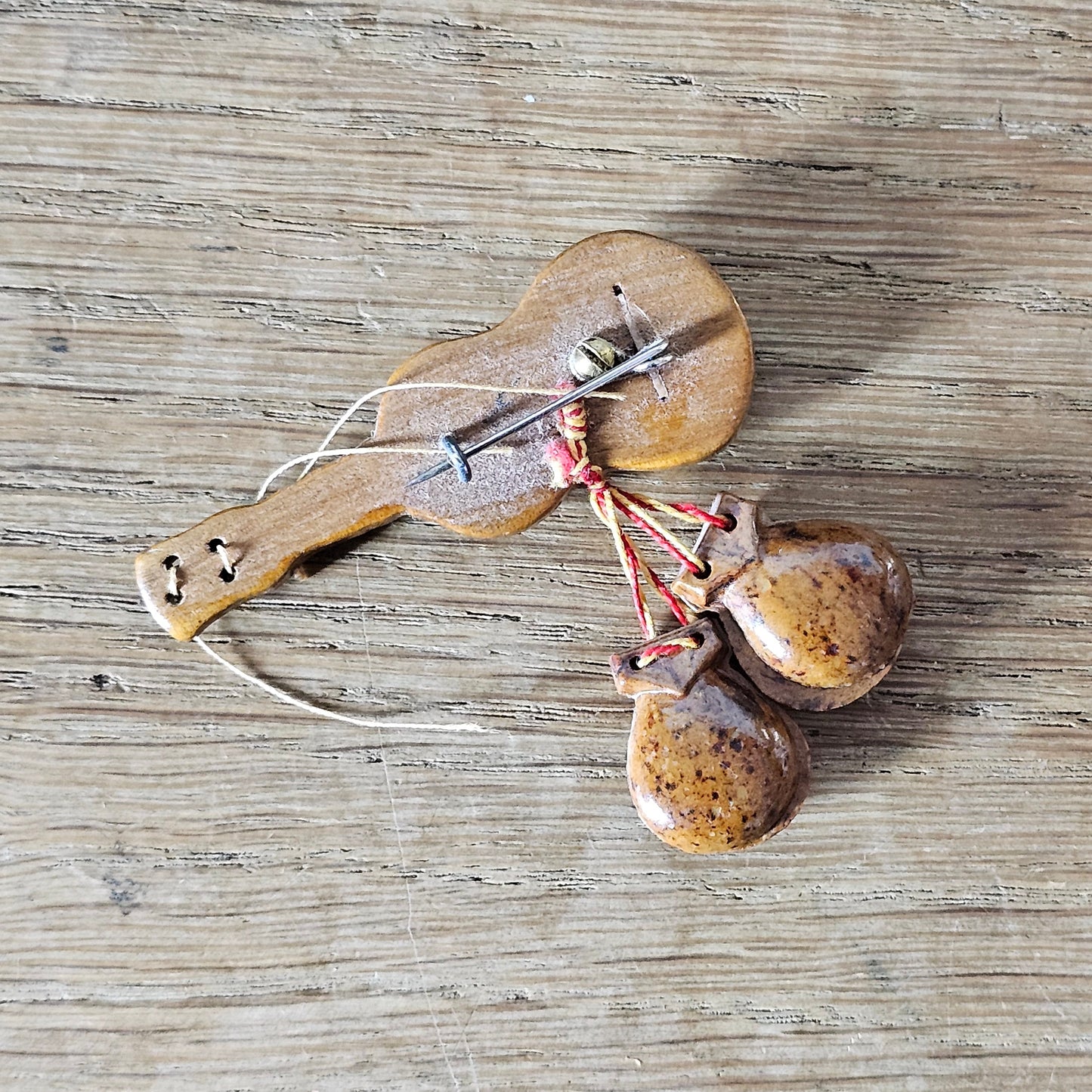 1940s hand-painted wooden guitar brooch with hanging maracas