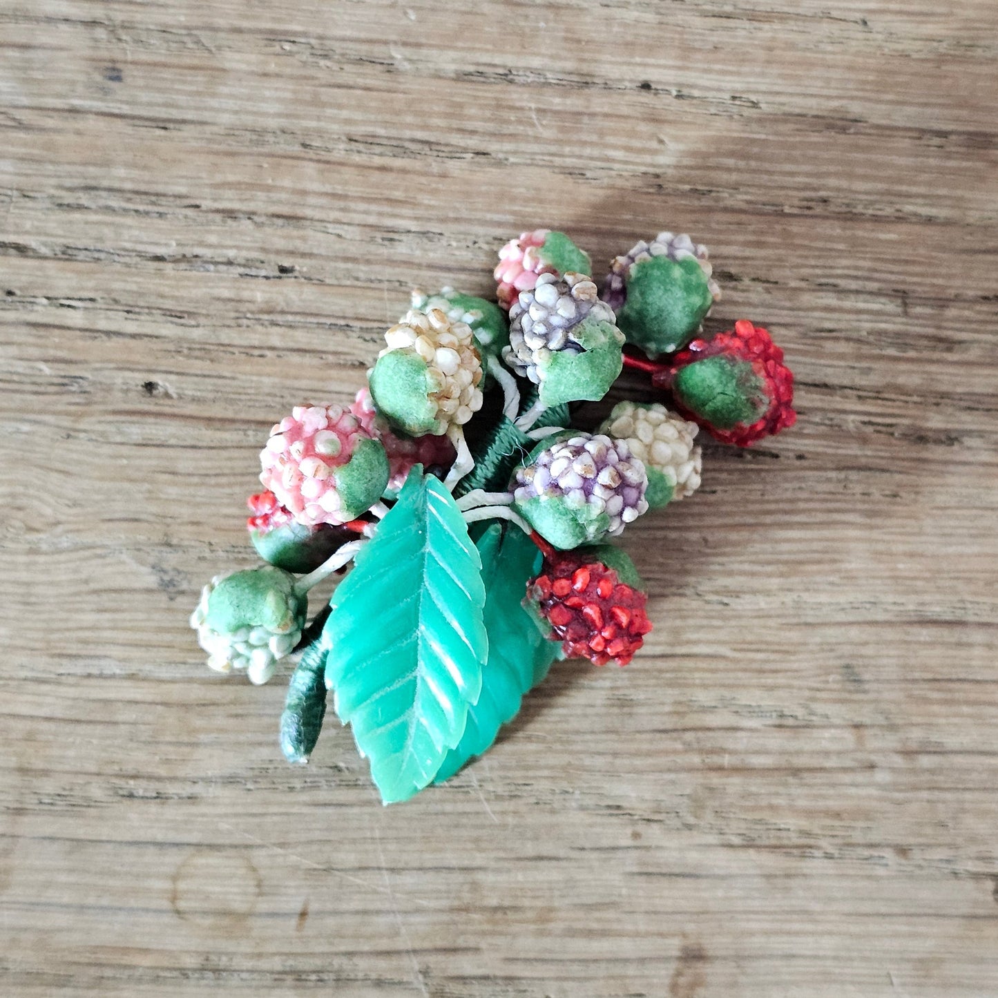 1930s/40s celluloid berry cluster brooch with moulded plastic leaves