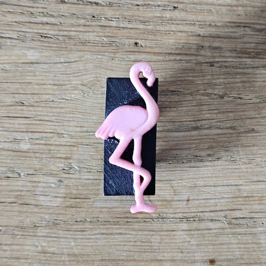 Home-made brooch using pink plastic flamingo on rectangular wooden bead
