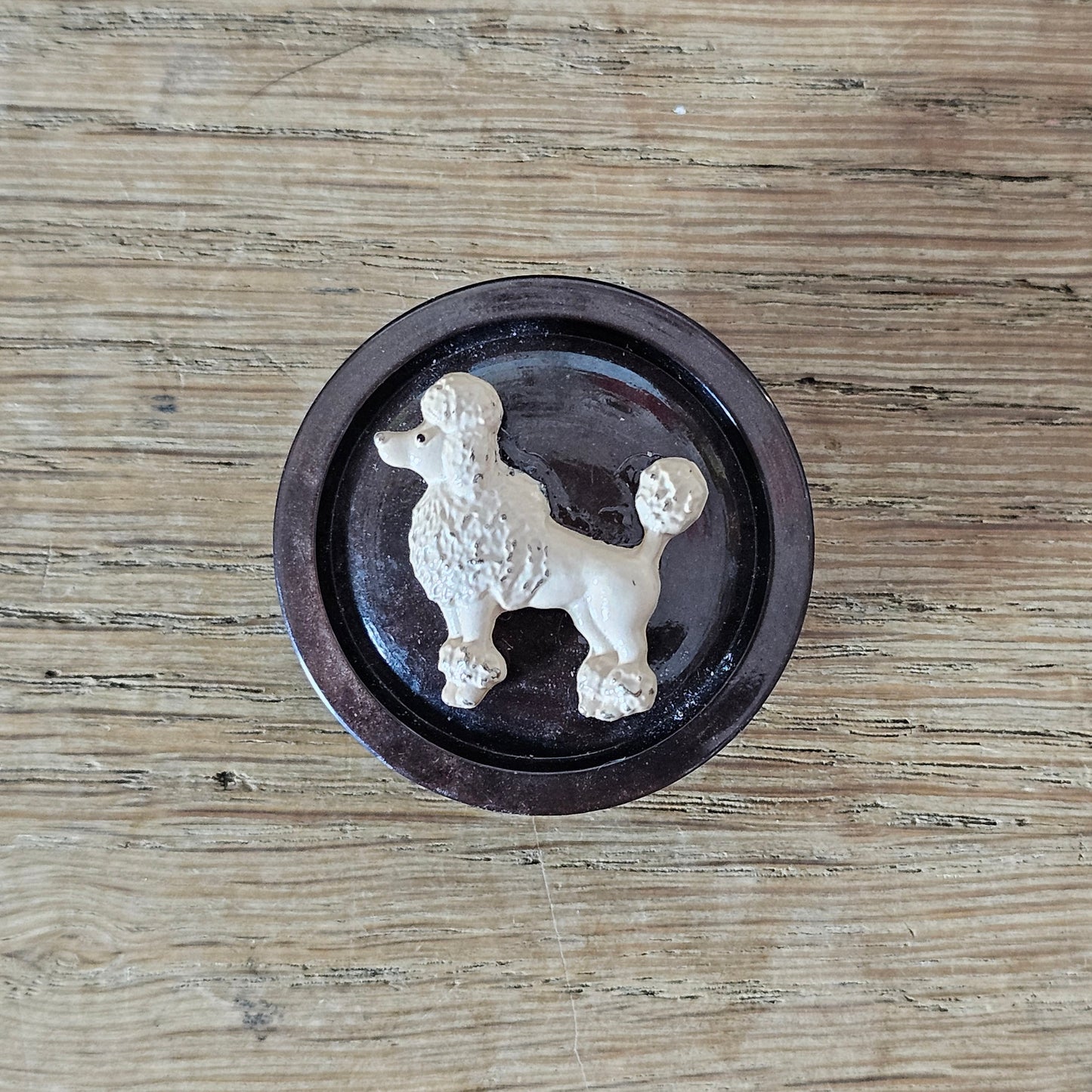 Home-made brooch using blush-coloured metal poodle and vintage button