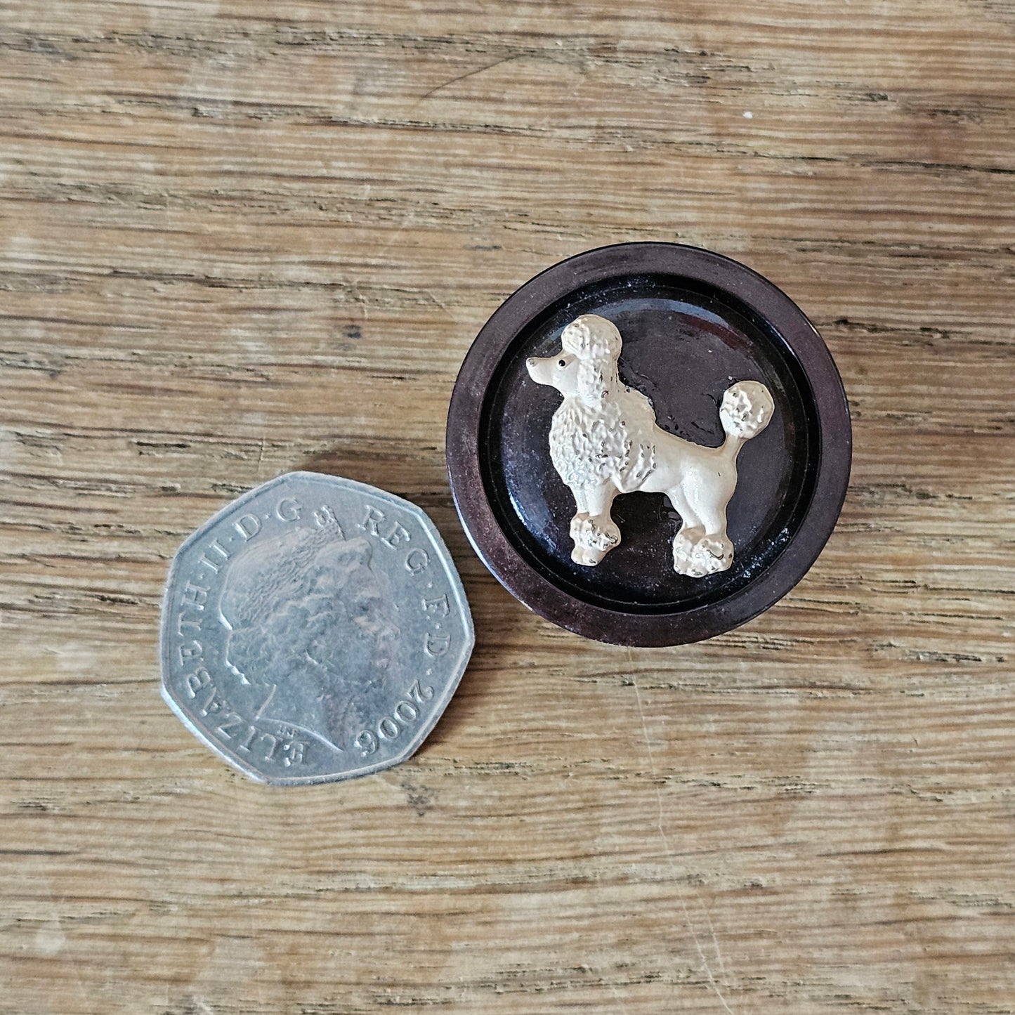 Home-made brooch using blush-coloured metal poodle and vintage button