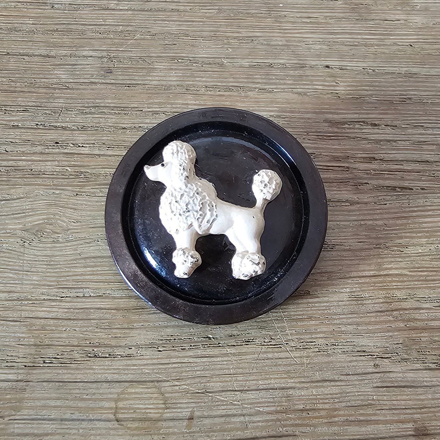 Home-made brooch using blush-coloured metal poodle and vintage button
