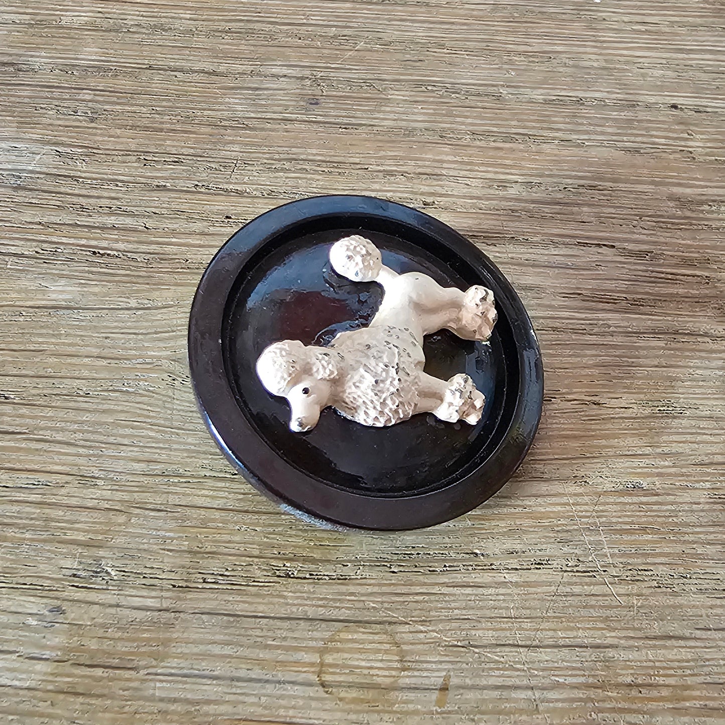 Home-made brooch using blush-coloured metal poodle and vintage button