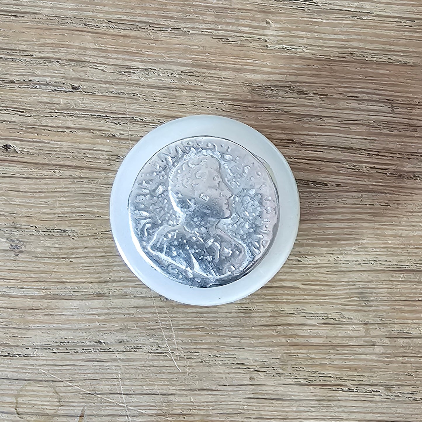 Home-made brooch using vintage metal profile button on MOP backing