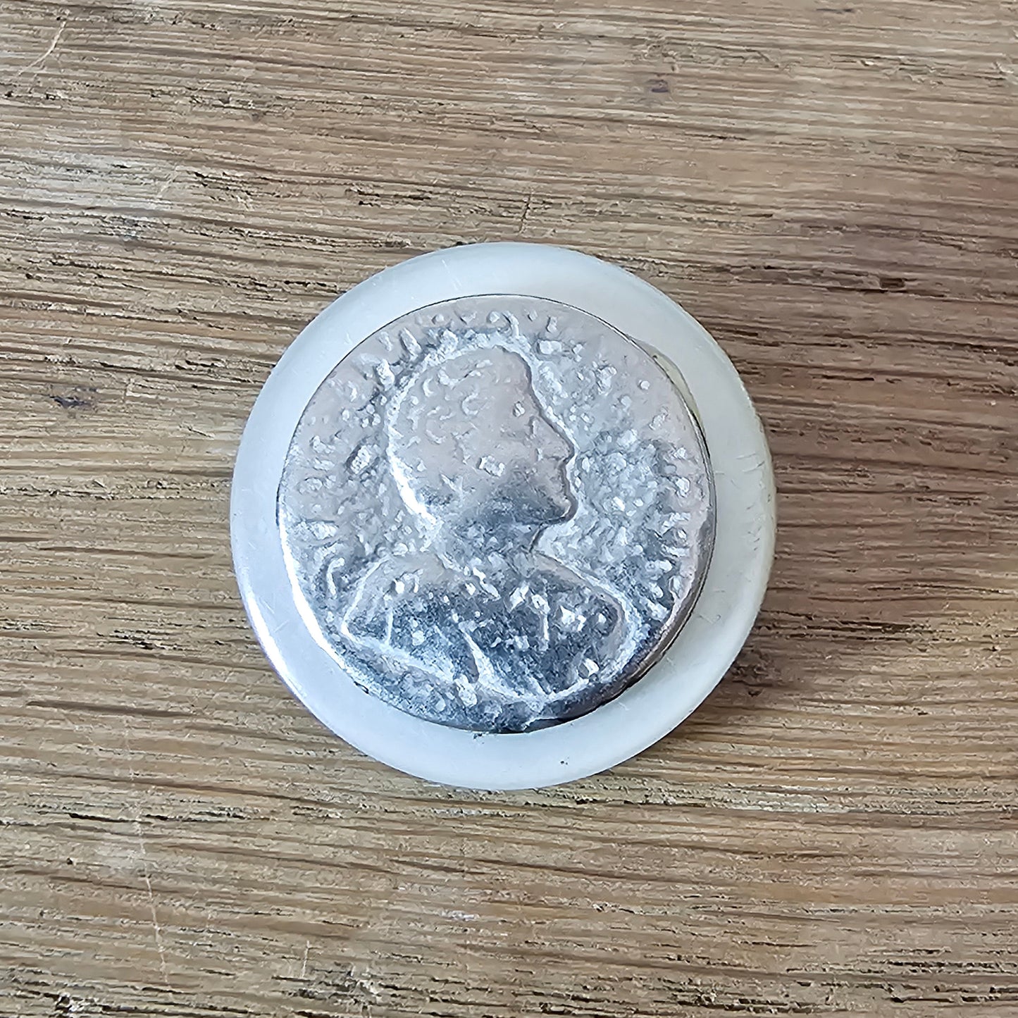 Home-made brooch using vintage metal profile button on MOP backing