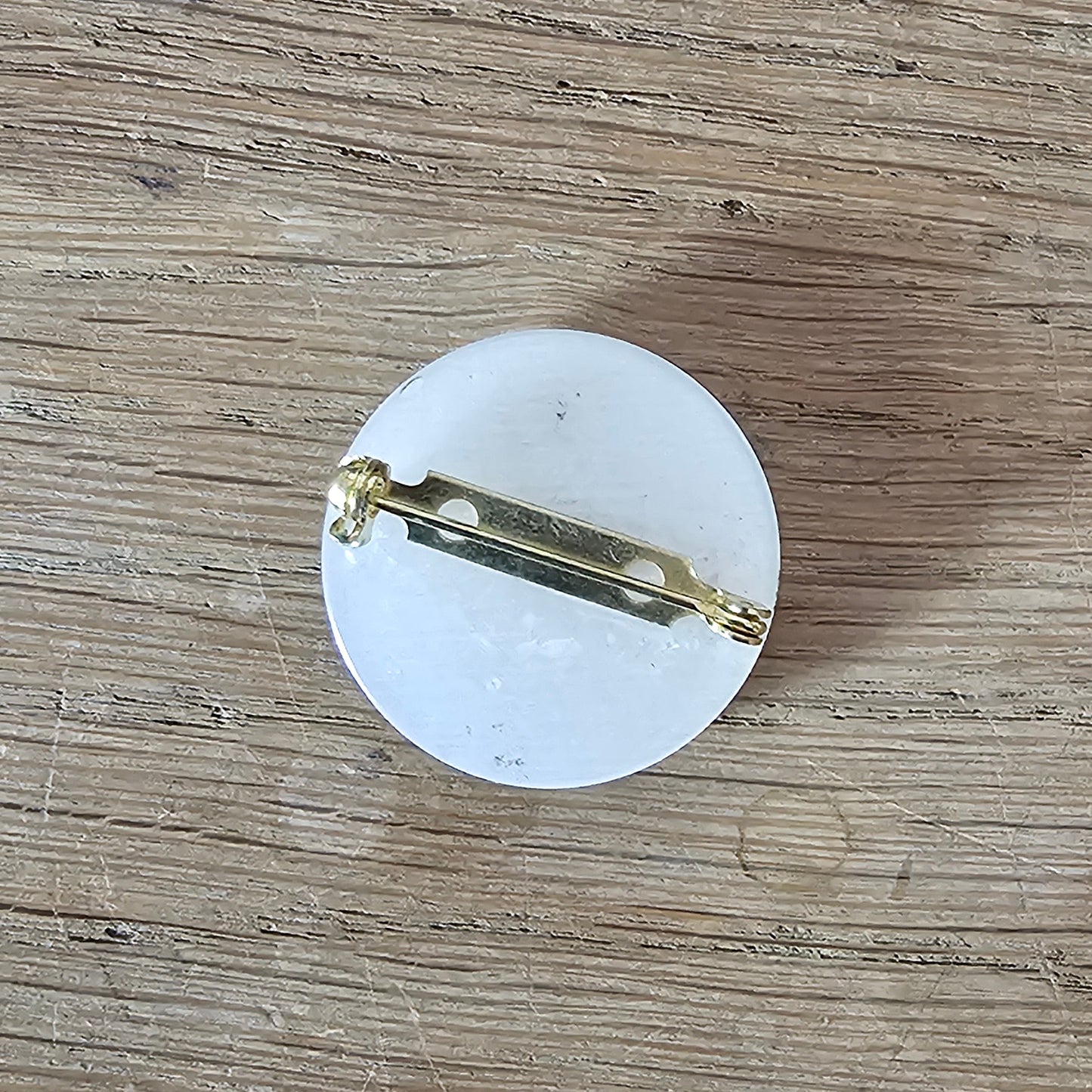 Home-made brooch using vintage metal profile button on MOP backing