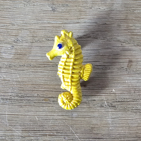 Home-made brooch using yellow celluloid seahorse with added diamante eye