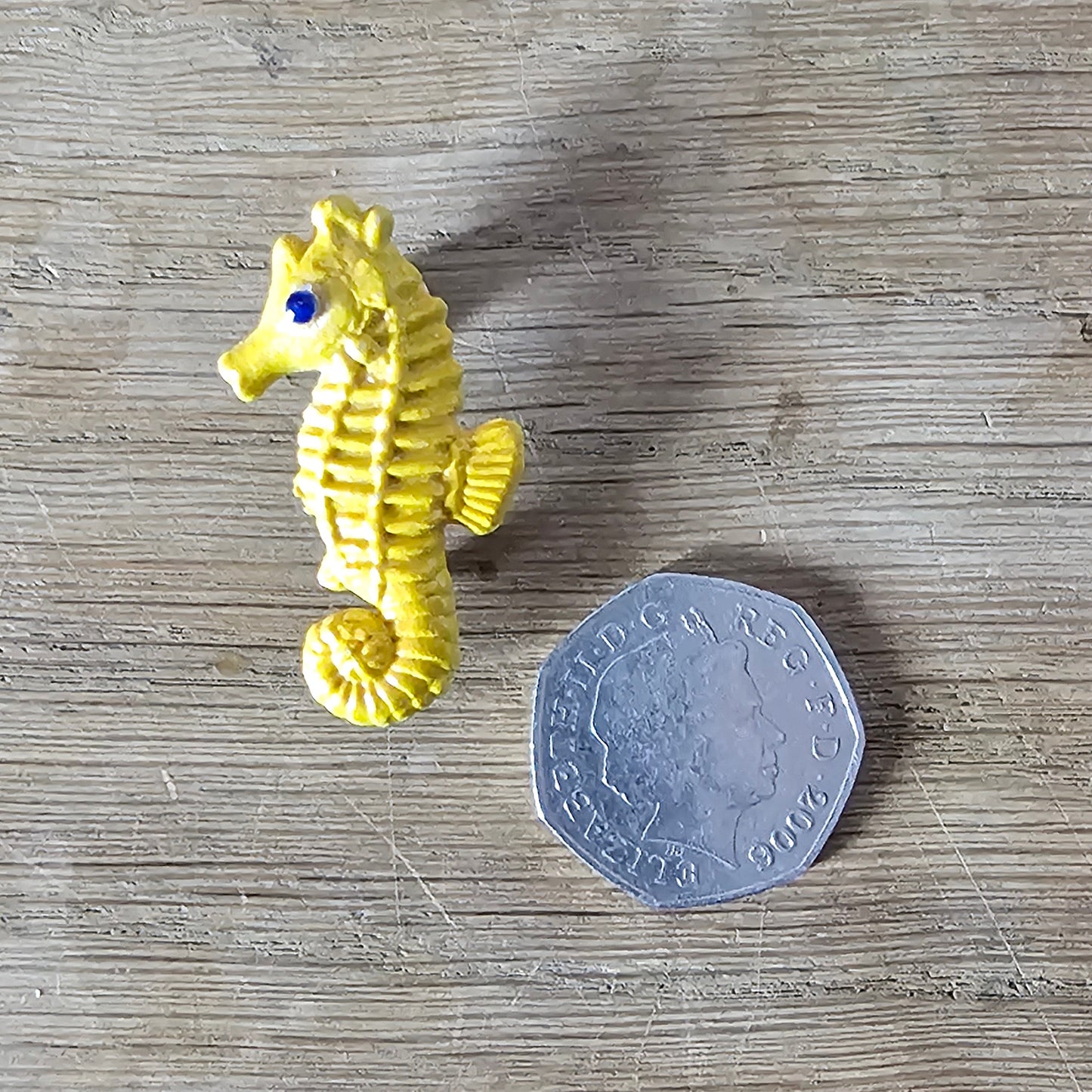 Home-made brooch using yellow celluloid seahorse with added diamante eye