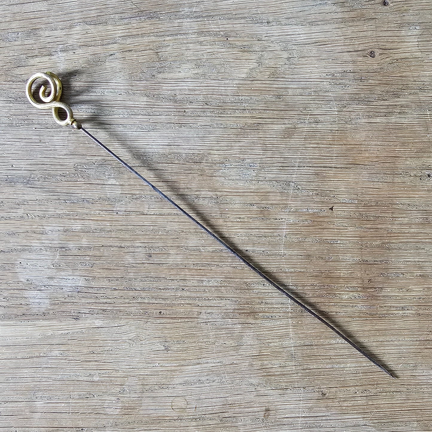 Early 20th century brass scrollwork hat pin