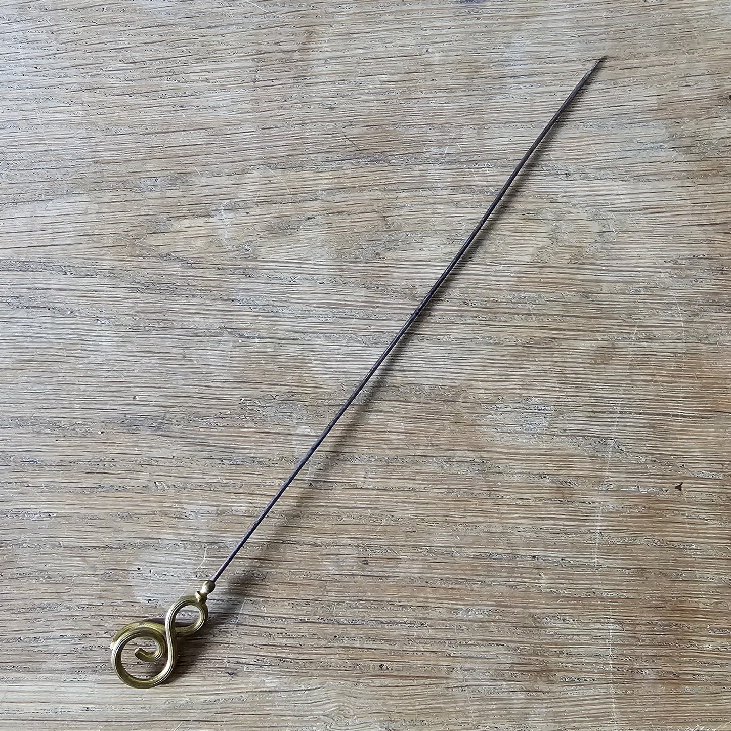 Early 20th century brass scrollwork hat pin