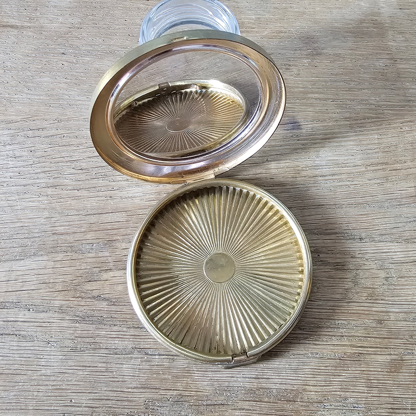 1960s gold-tone powder compact with mod fashion illustration design