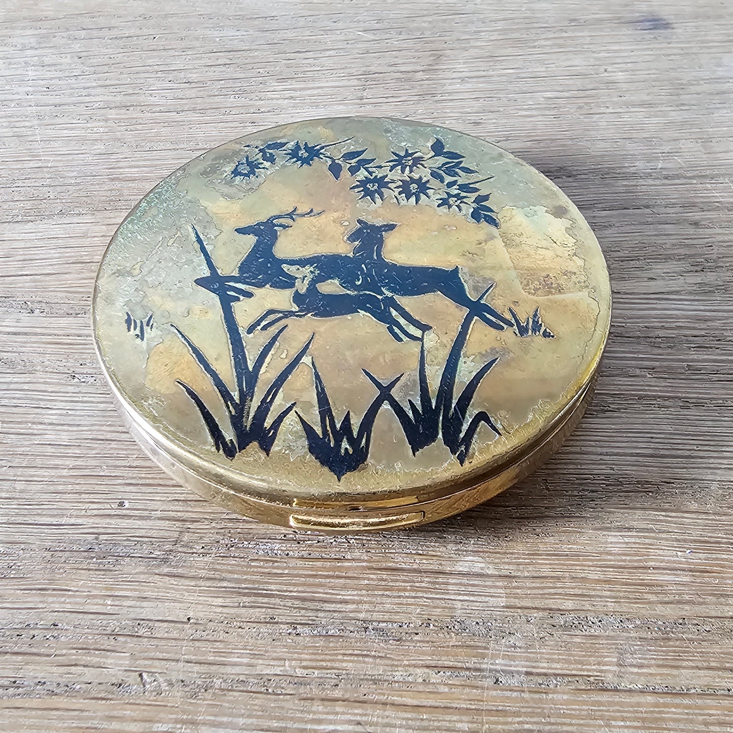 1950s gold-tone powder compact with deer silhouette design