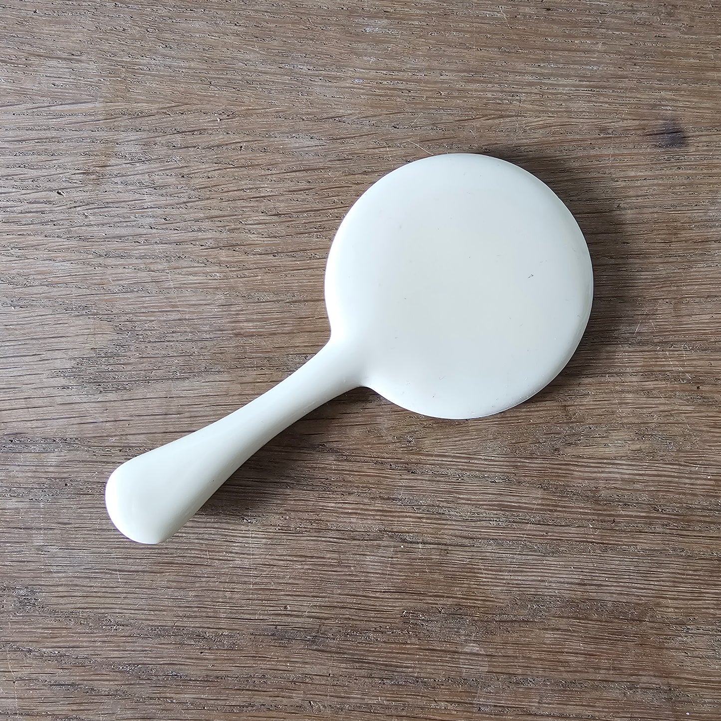 1960s cream plastic vanity hand mirror with shell detail handle