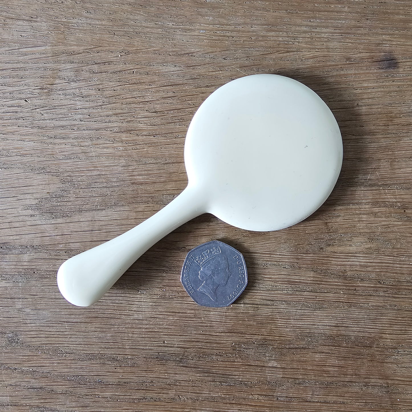 1960s cream plastic vanity hand mirror with shell detail handle
