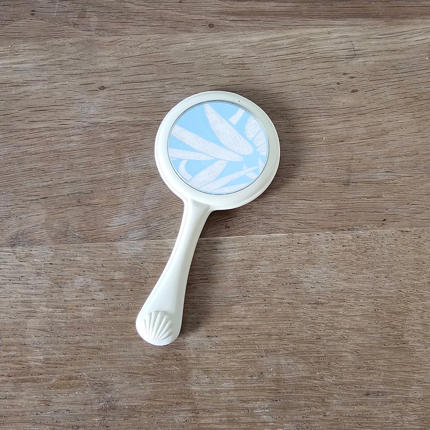 1960s cream plastic vanity hand mirror with shell detail handle