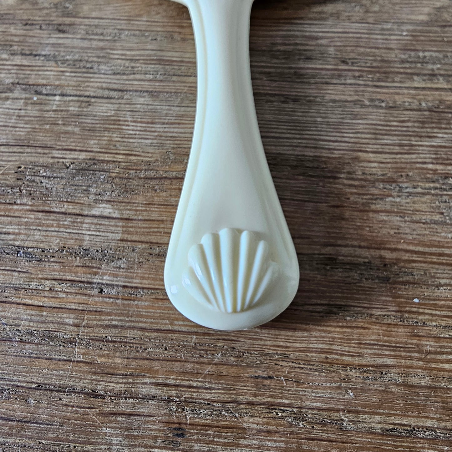 1960s cream plastic vanity hand mirror with shell detail handle