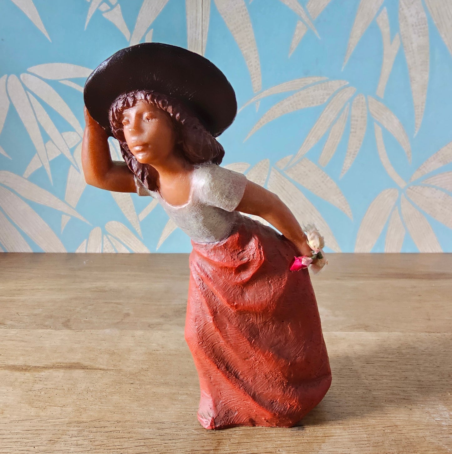 1990s signed sculpted resin country girl figurine leaning into the wind