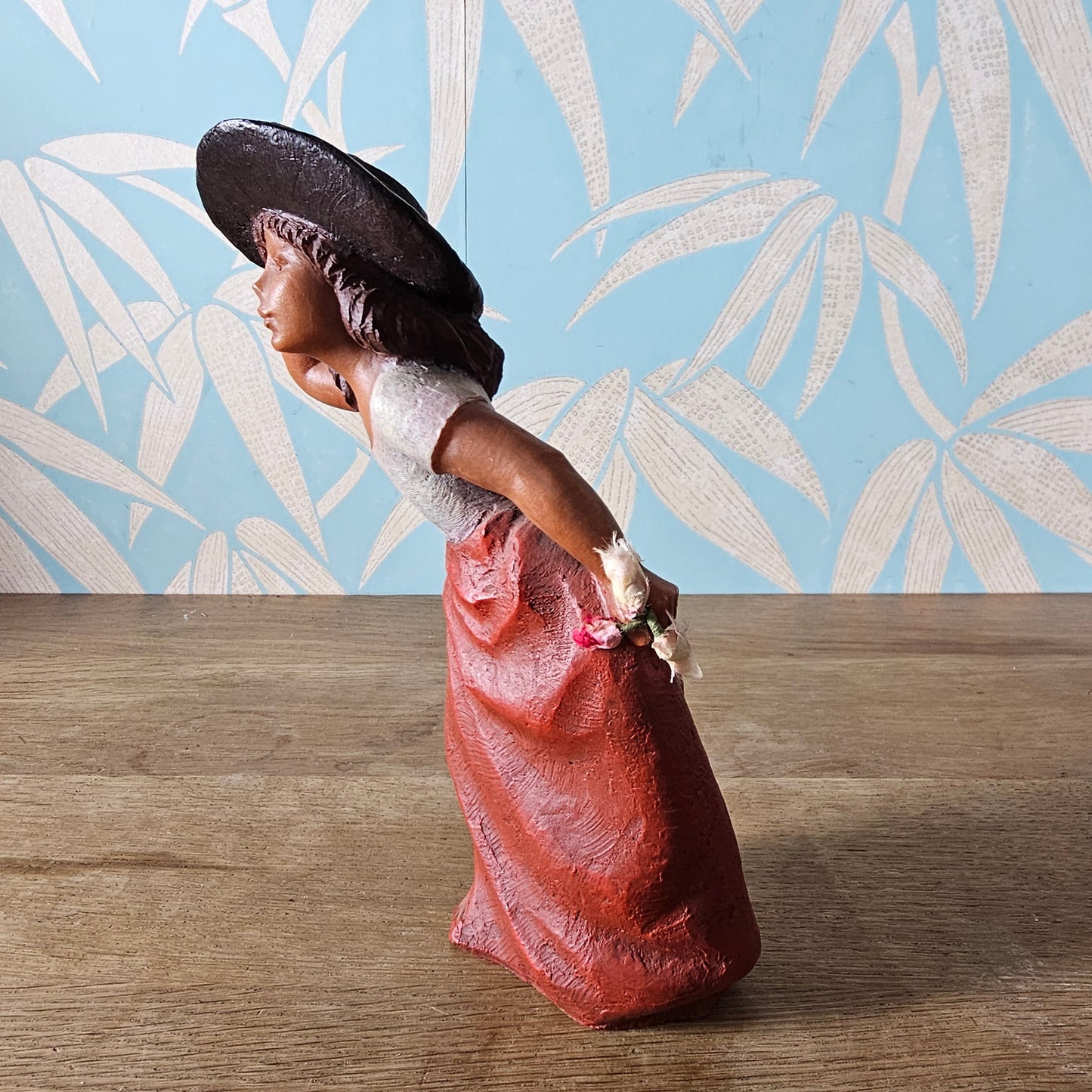 1990s signed sculpted resin country girl figurine leaning into the wind