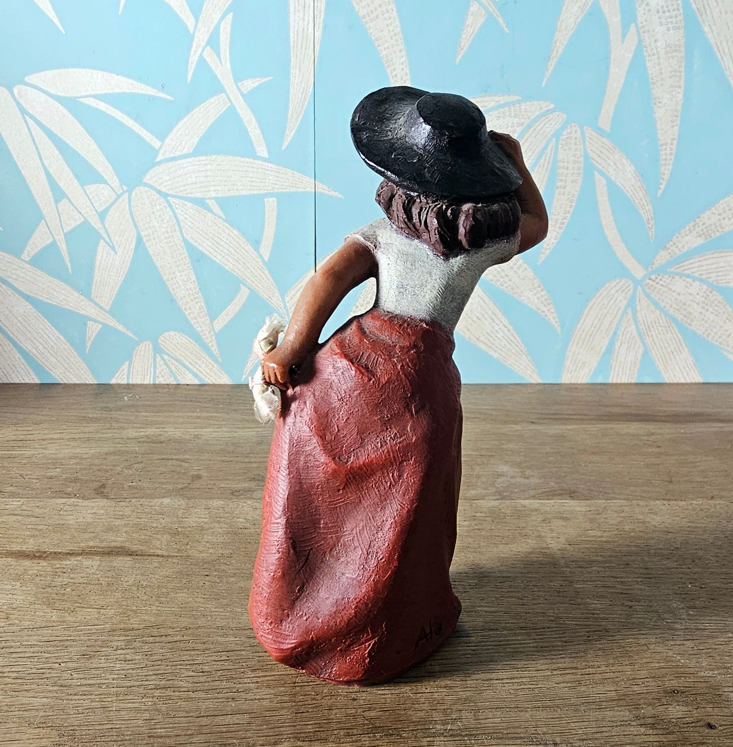 1990s signed sculpted resin country girl figurine leaning into the wind