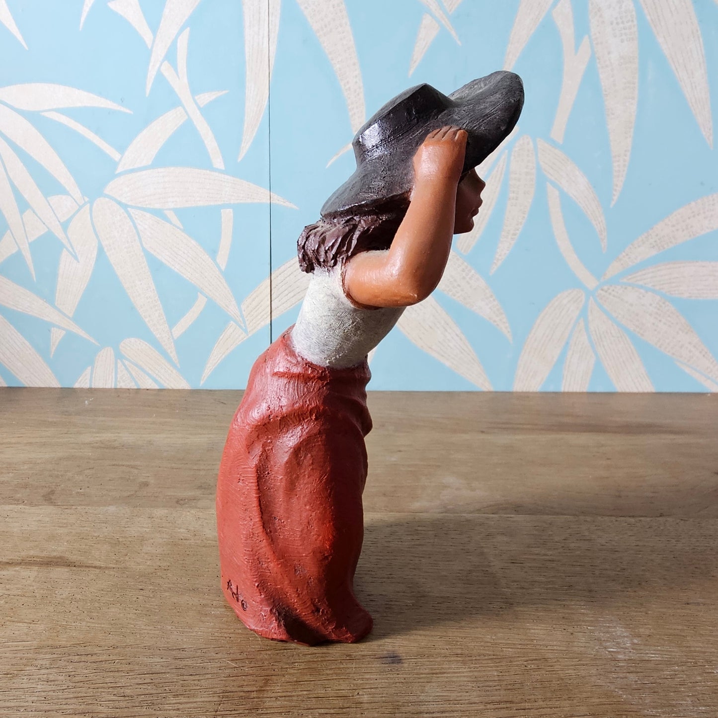 1990s signed sculpted resin country girl figurine leaning into the wind