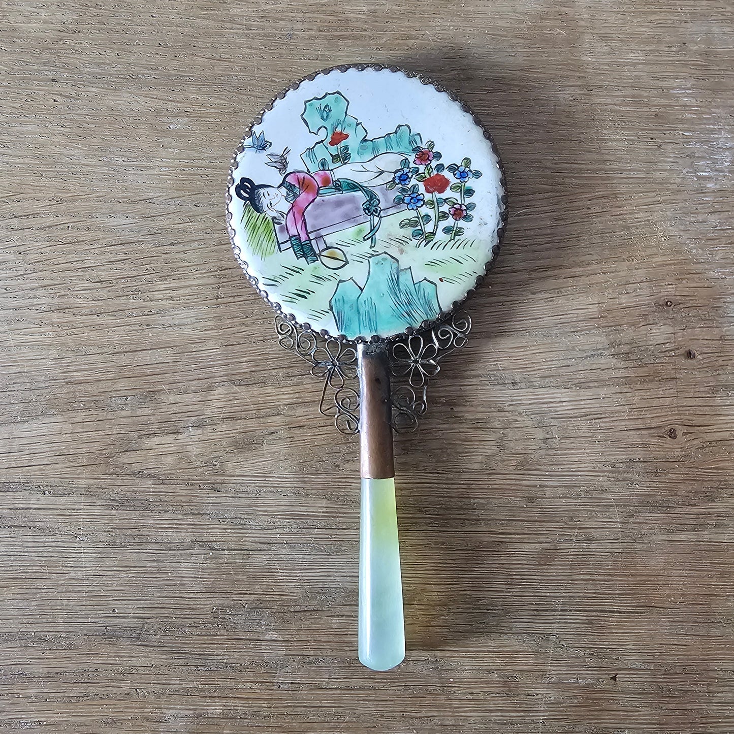 Art Deco hand-painted porcelain vanity mirror with serpentine handle