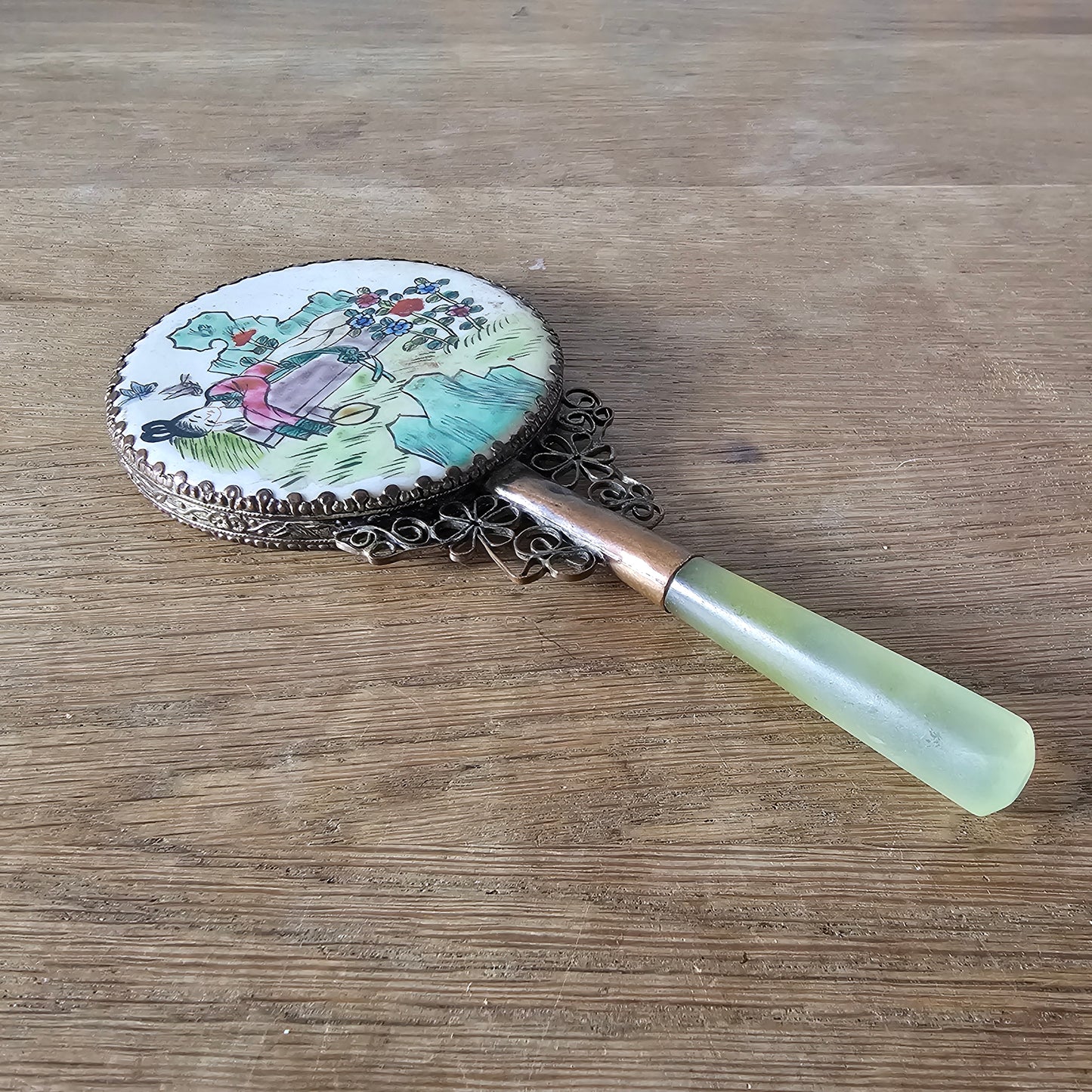 Art Deco hand-painted porcelain vanity mirror with serpentine handle