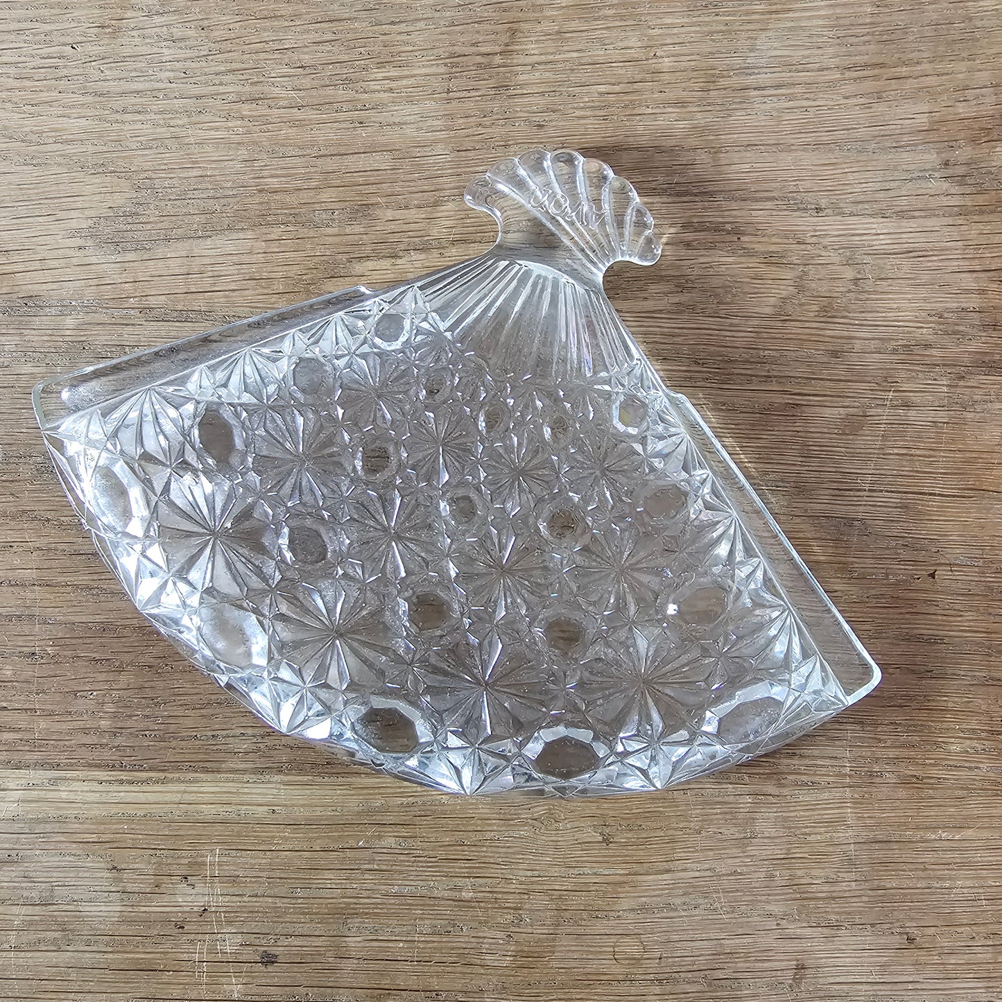 1970s Avon pressed glass fan-shaped trinket dish with starburst pattern
