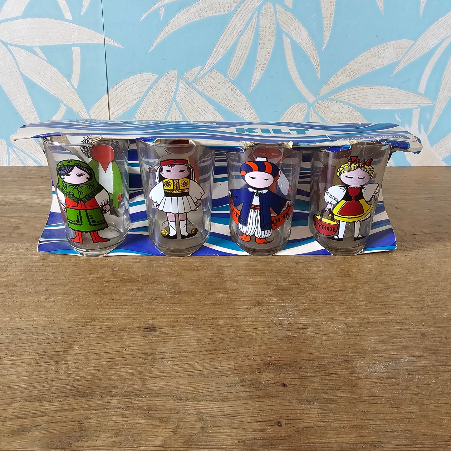 Set of four 1960s Saint-Gobain “World Doll” character tumblers with original box