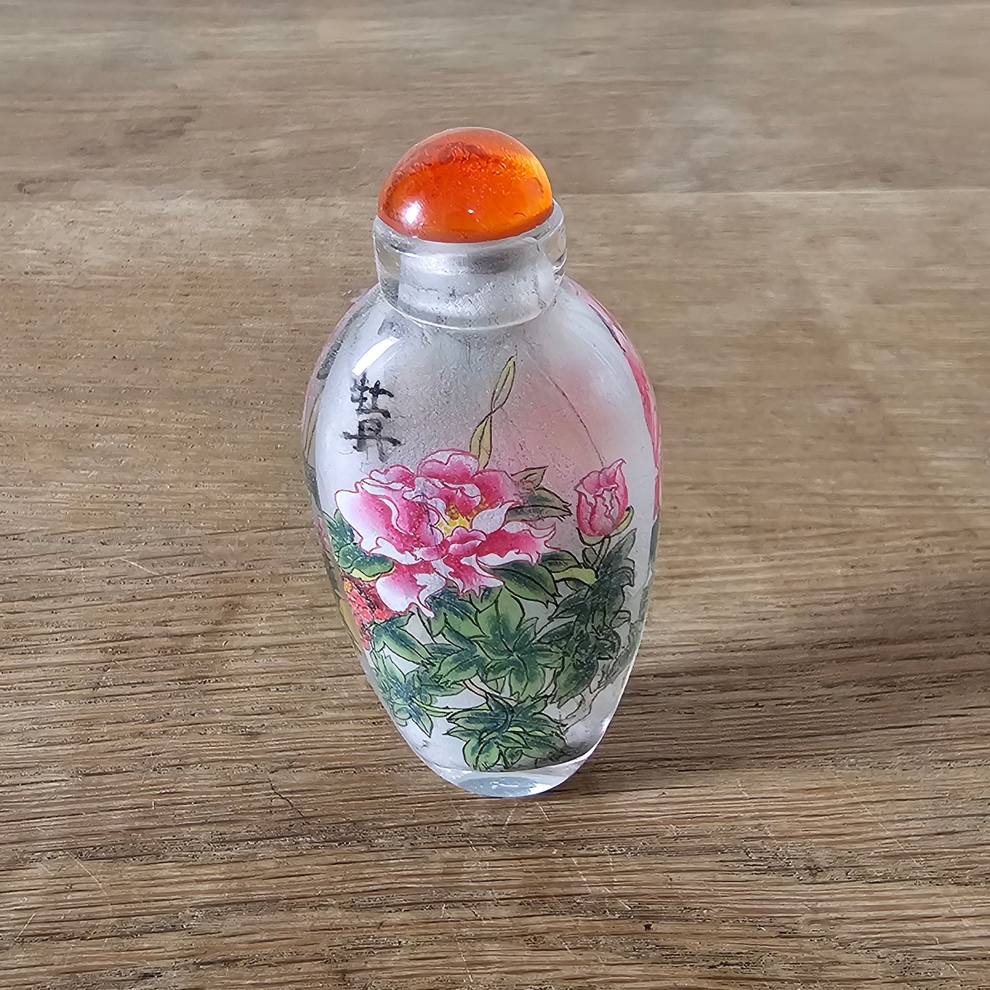 Vintage Chinese reverse painted Peonies glass snuff bottle with orange glass stopper