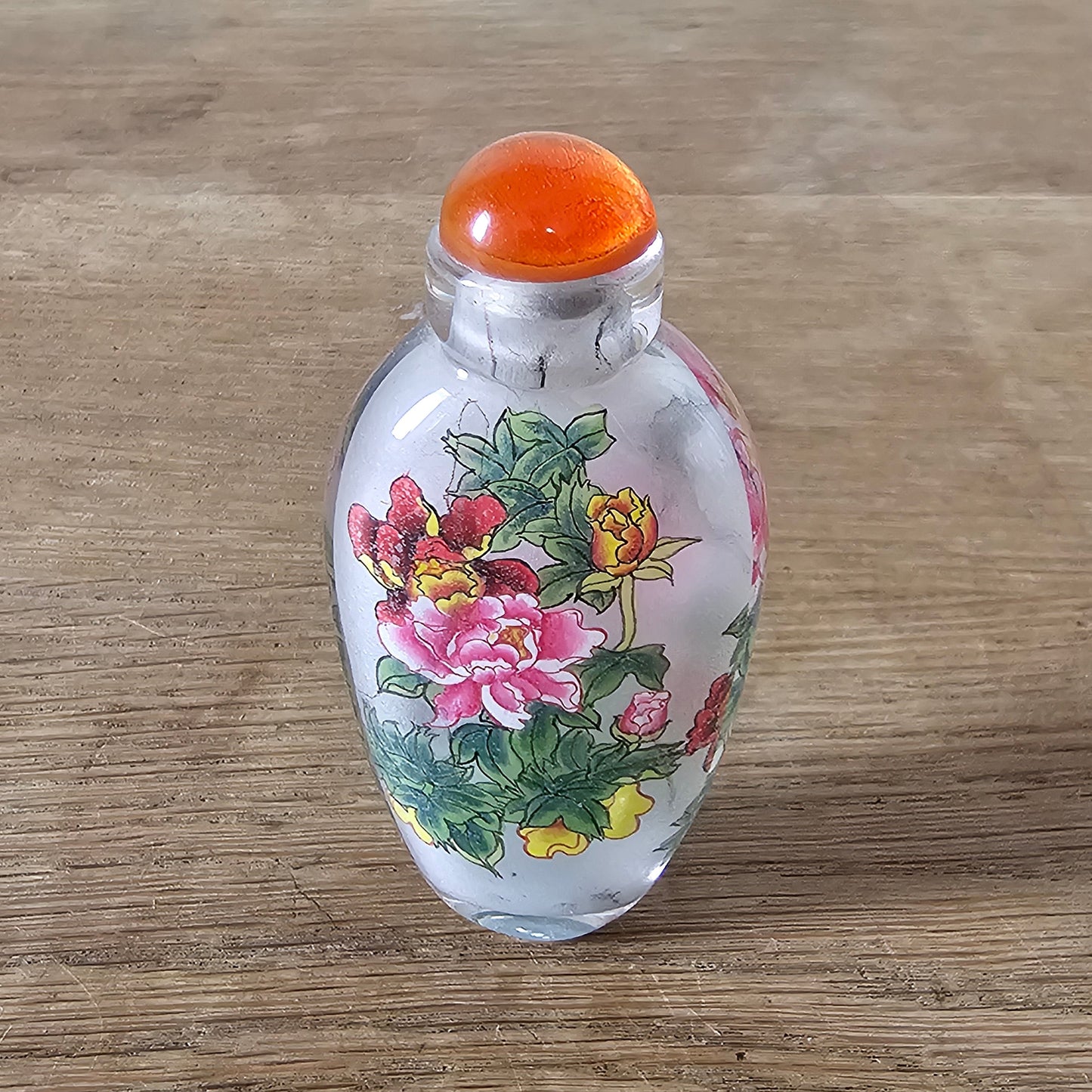 Vintage Chinese reverse painted Peonies glass snuff bottle with orange glass stopper