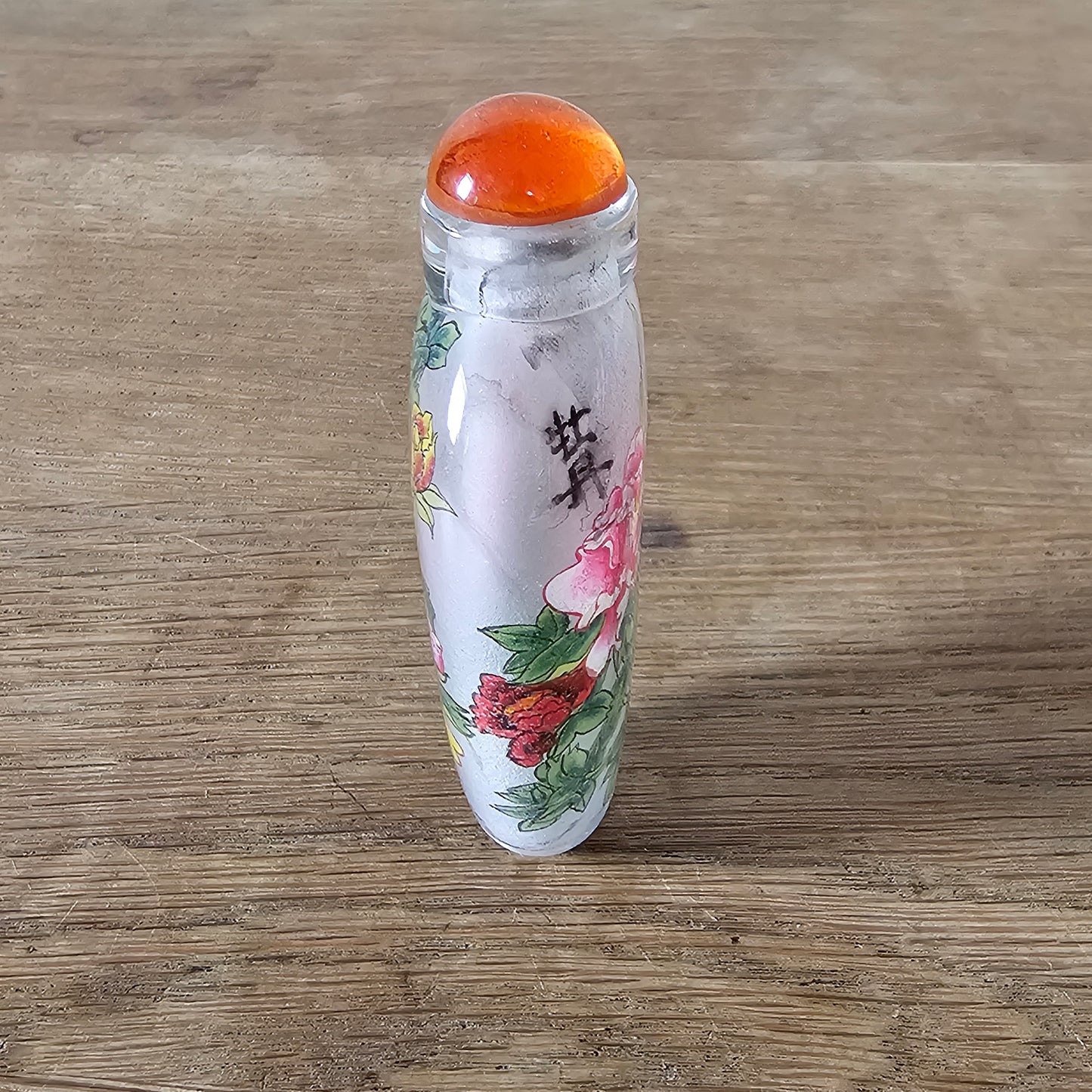 Vintage Chinese reverse painted Peonies glass snuff bottle with orange glass stopper