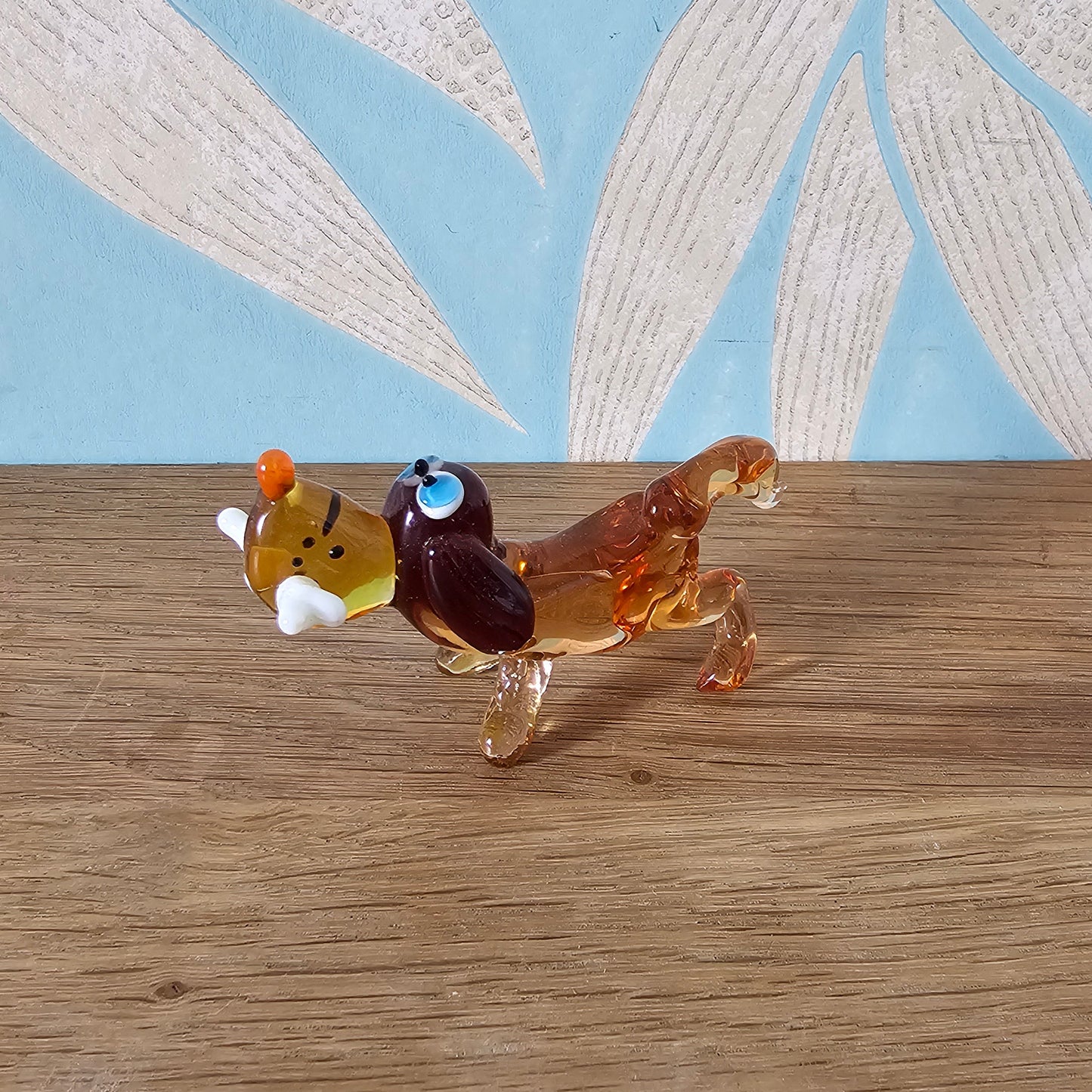 1970s Murano-style amber art glass daschund with bone figurine