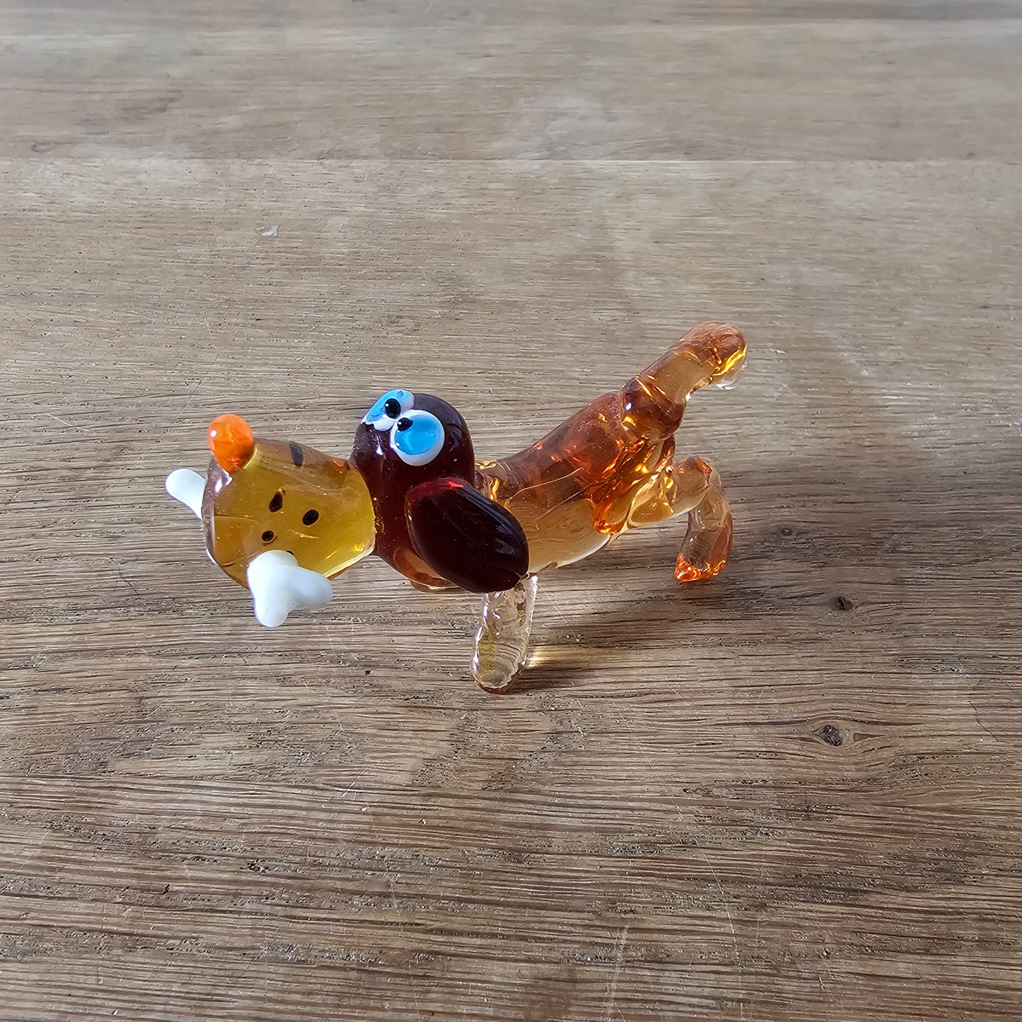 1970s Murano-style amber art glass daschund with bone figurine