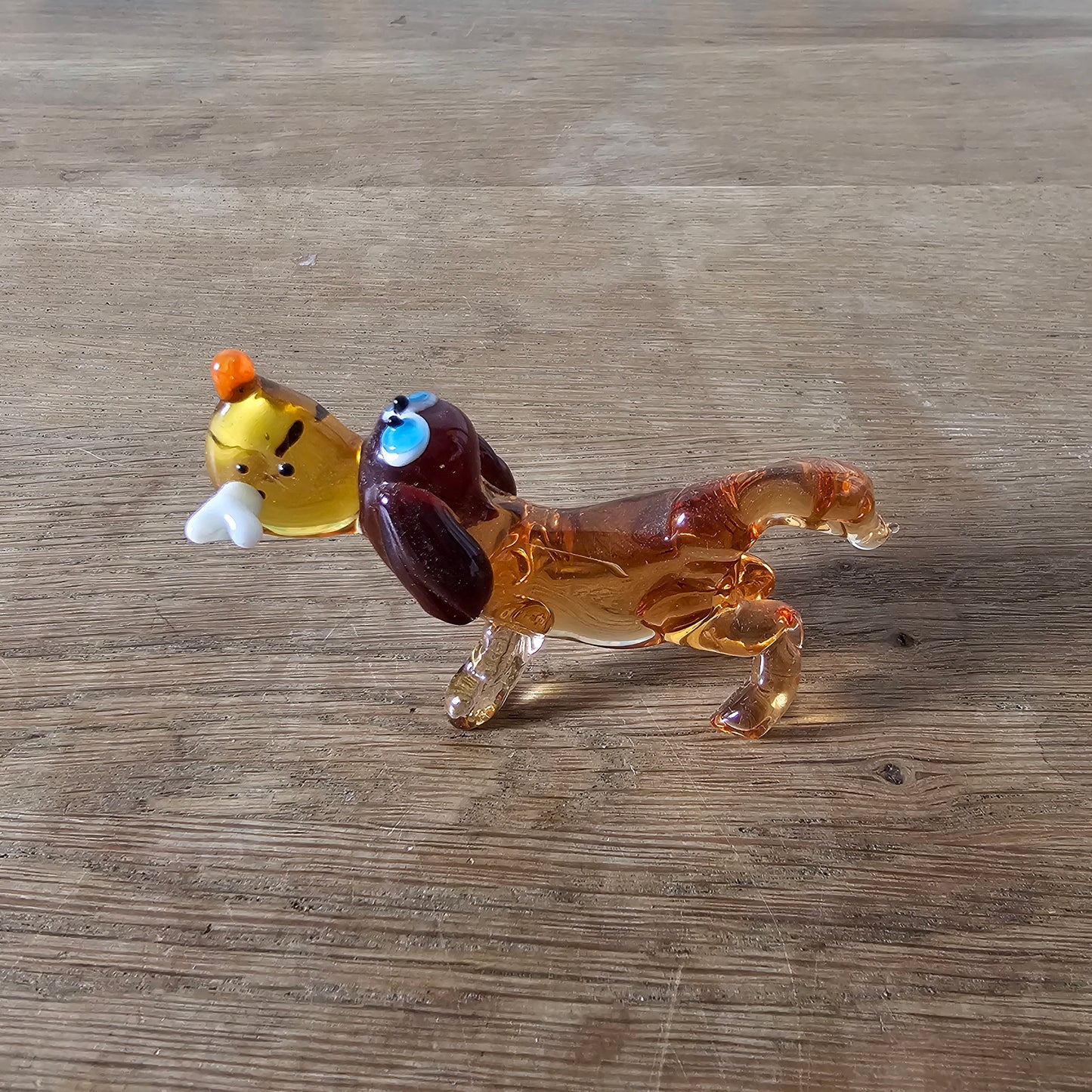 1970s Murano-style amber art glass daschund with bone figurine