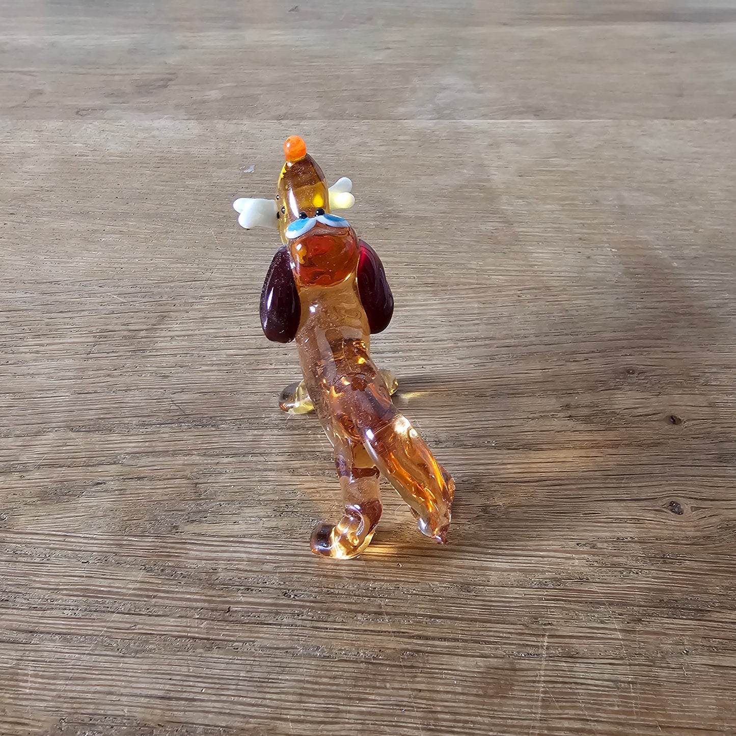 1970s Murano-style amber art glass daschund with bone figurine