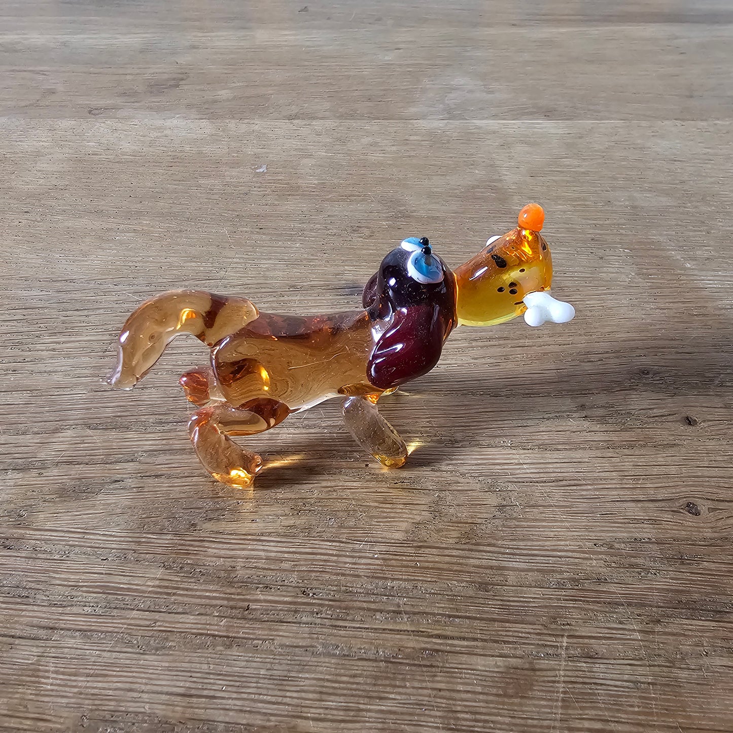 1970s Murano-style amber art glass daschund with bone figurine