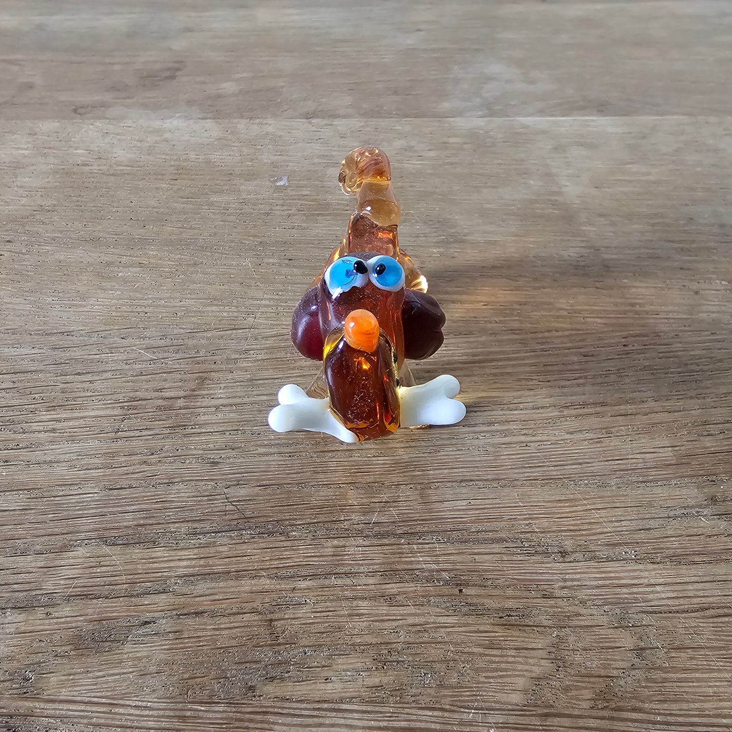 1970s Murano-style amber art glass daschund with bone figurine