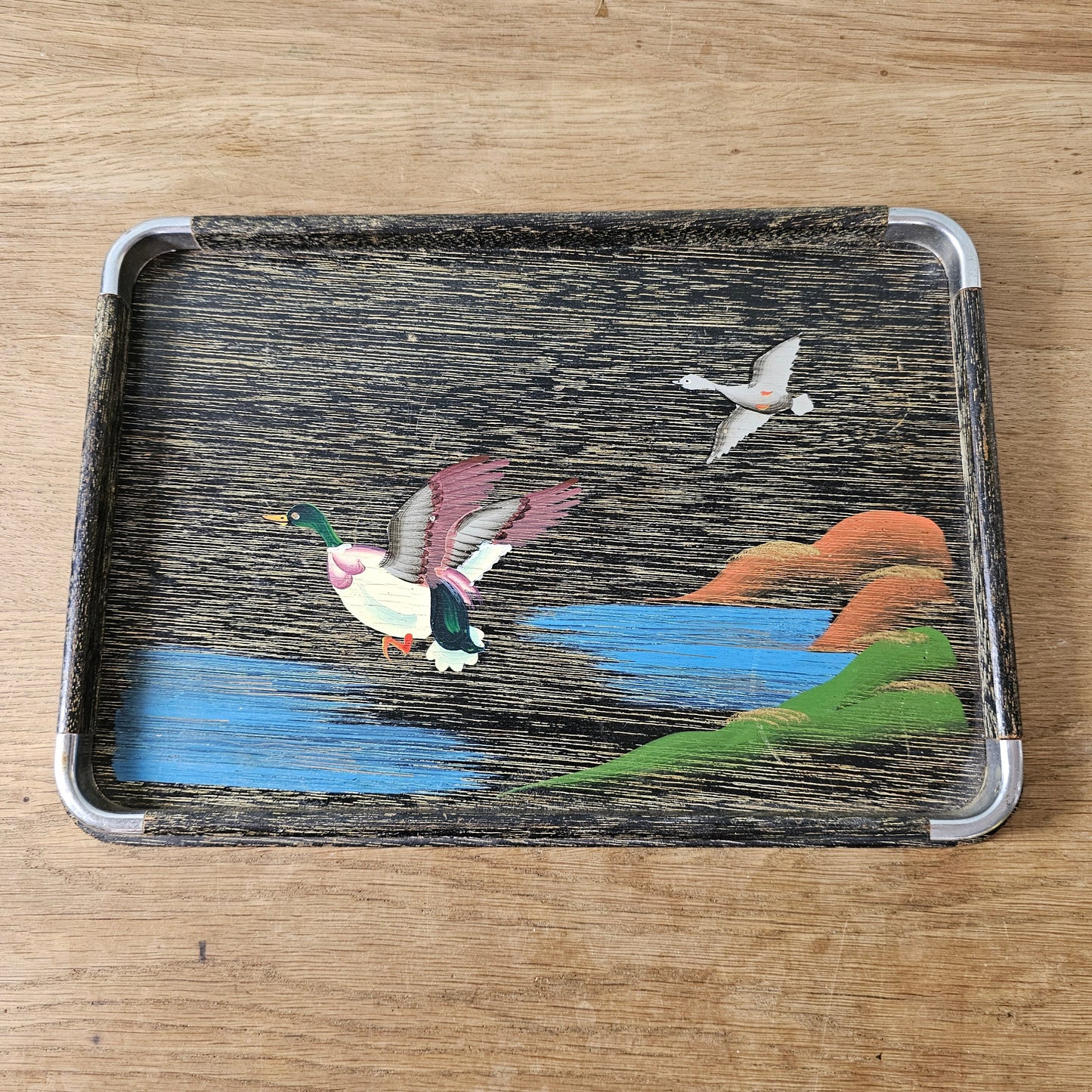 Set of three 1950s hand-painted black serving trays with flying duck detail