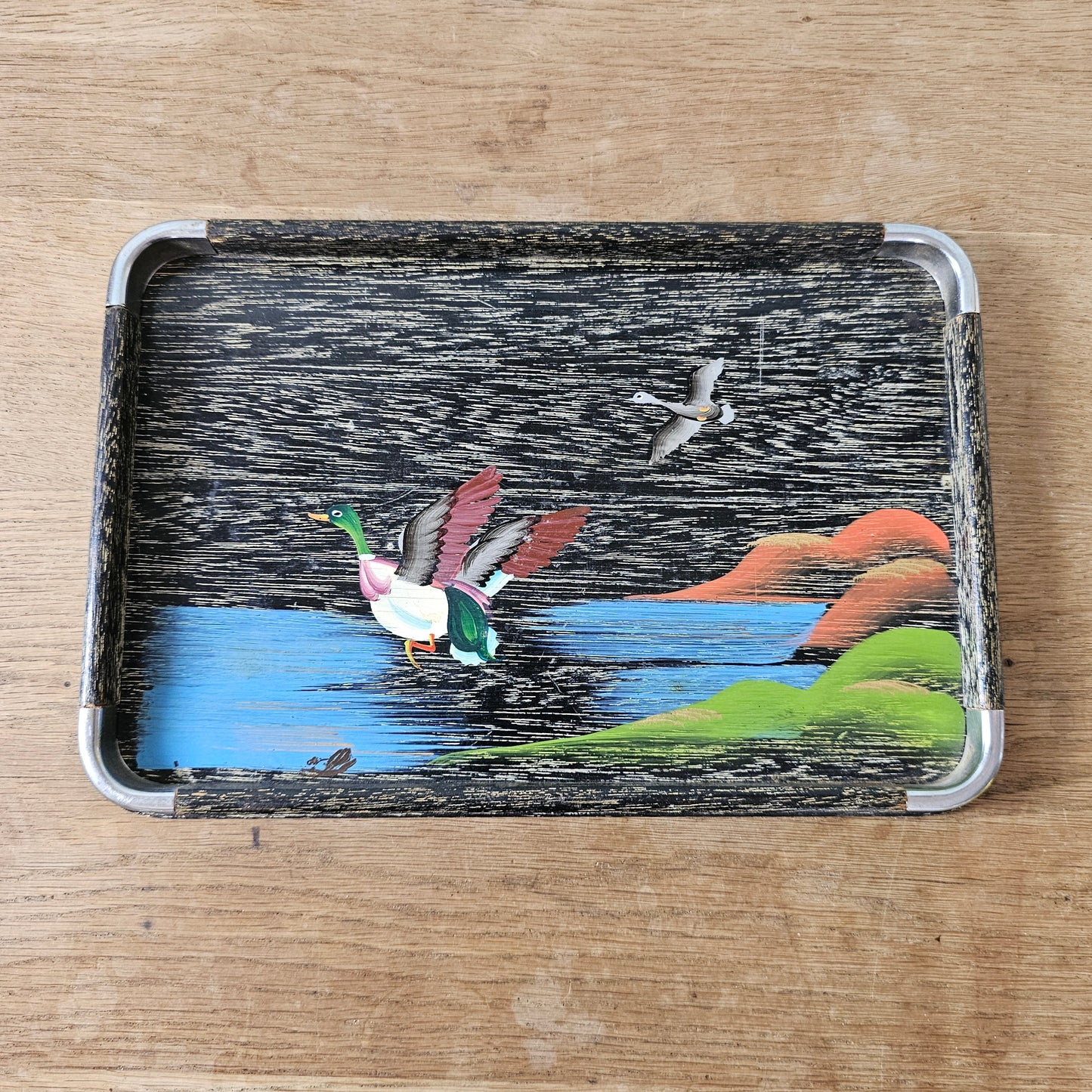 Set of three 1950s hand-painted black serving trays with flying duck detail