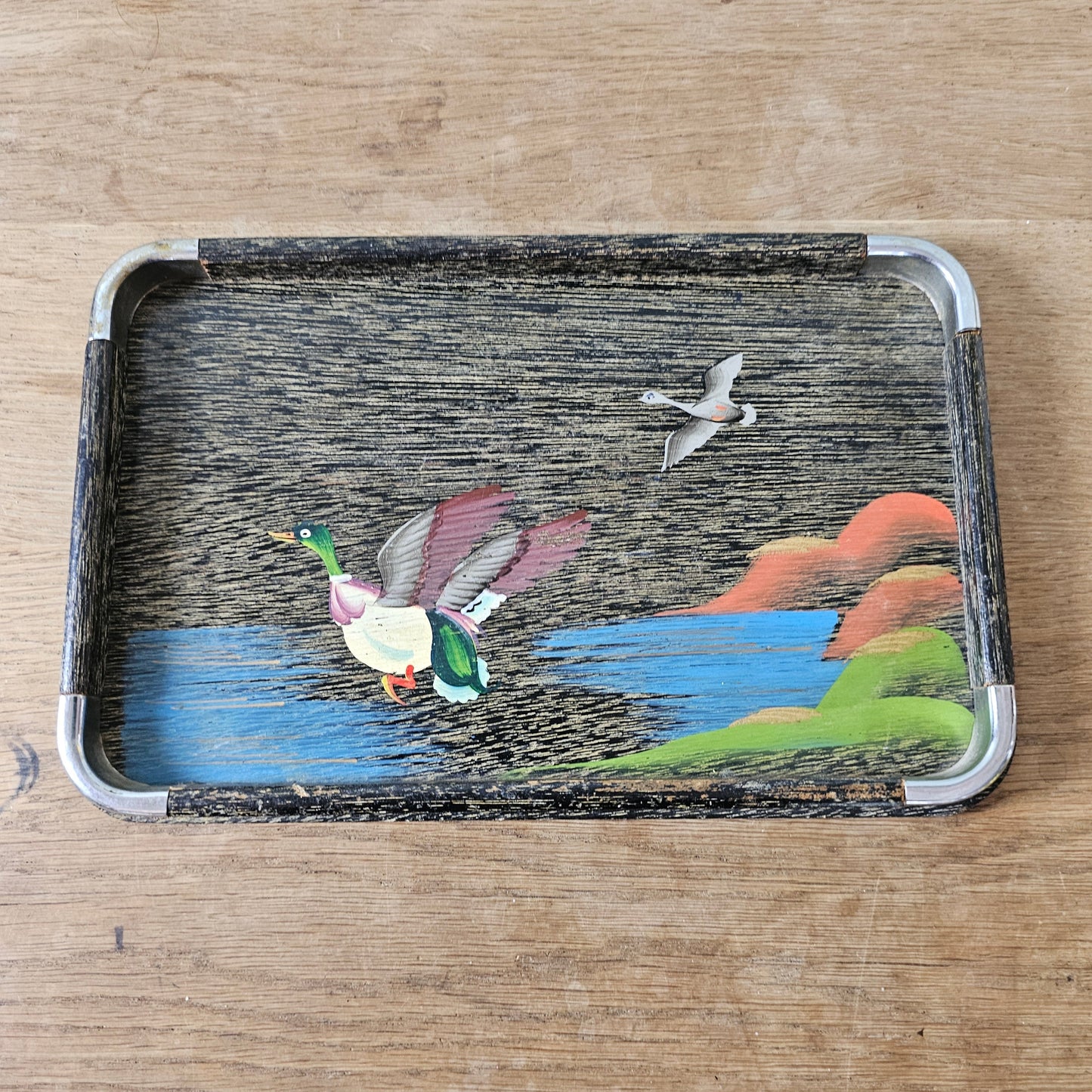 Set of three 1950s hand-painted black serving trays with flying duck detail