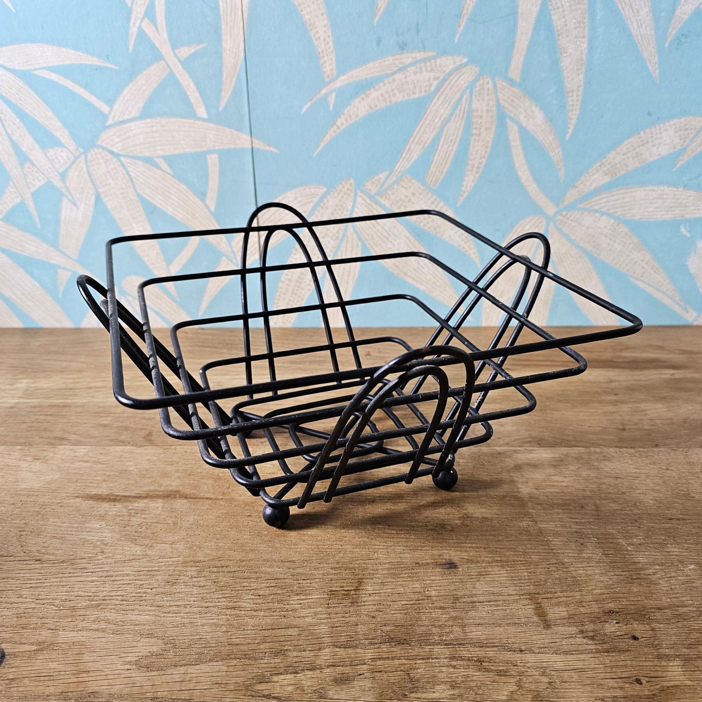 Mid-century atomic black wire fruit basket with ball feet