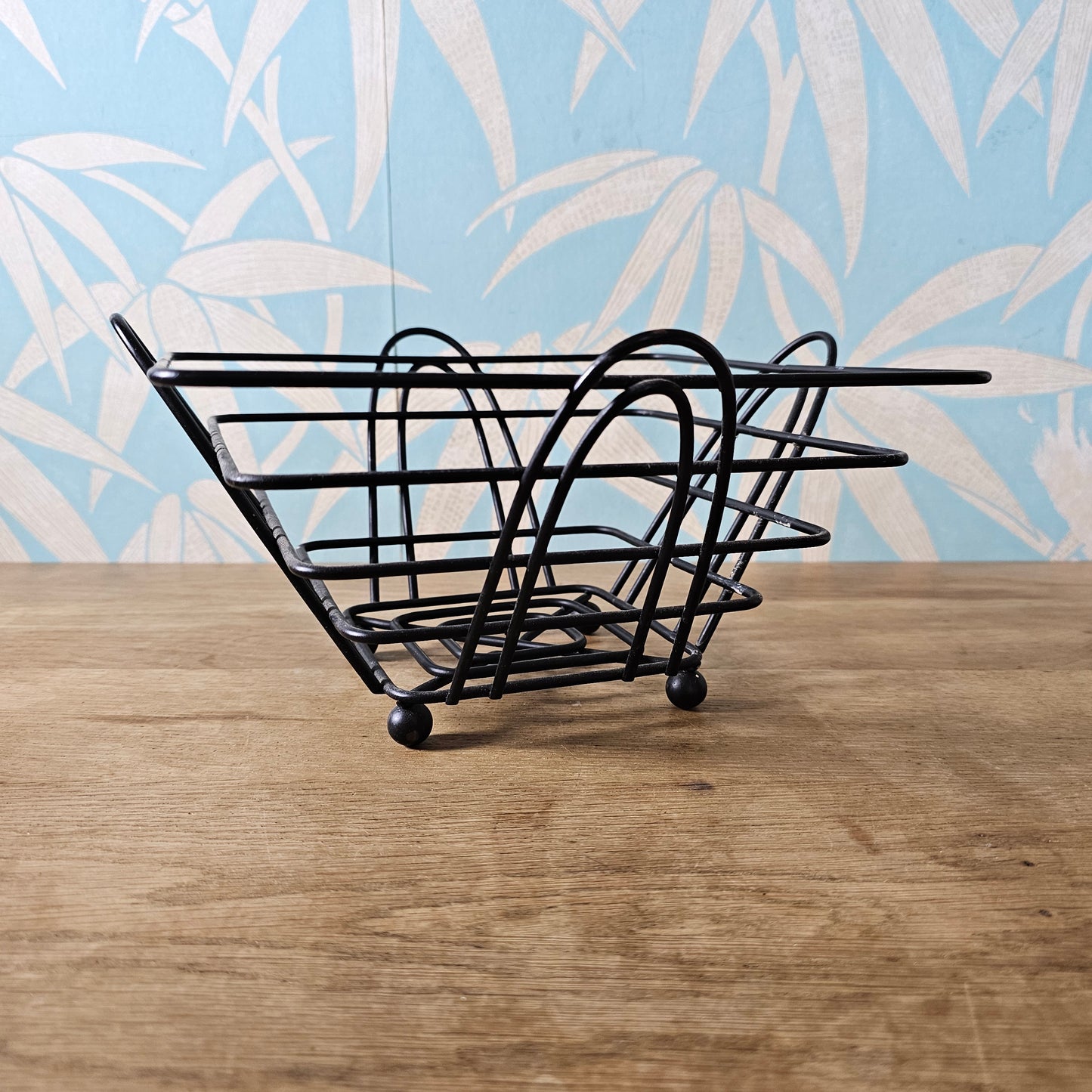 Mid-century atomic black wire fruit basket with ball feet