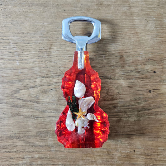 1950s red lucite seaside souvenir bottle opener with embedded shells