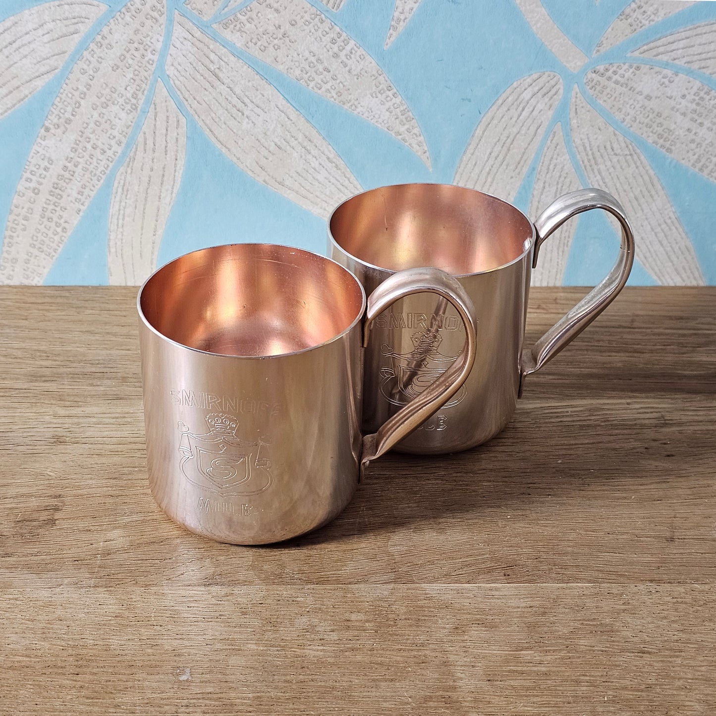Pair of vintage Smirnoff rose-gold & copper mule mugs