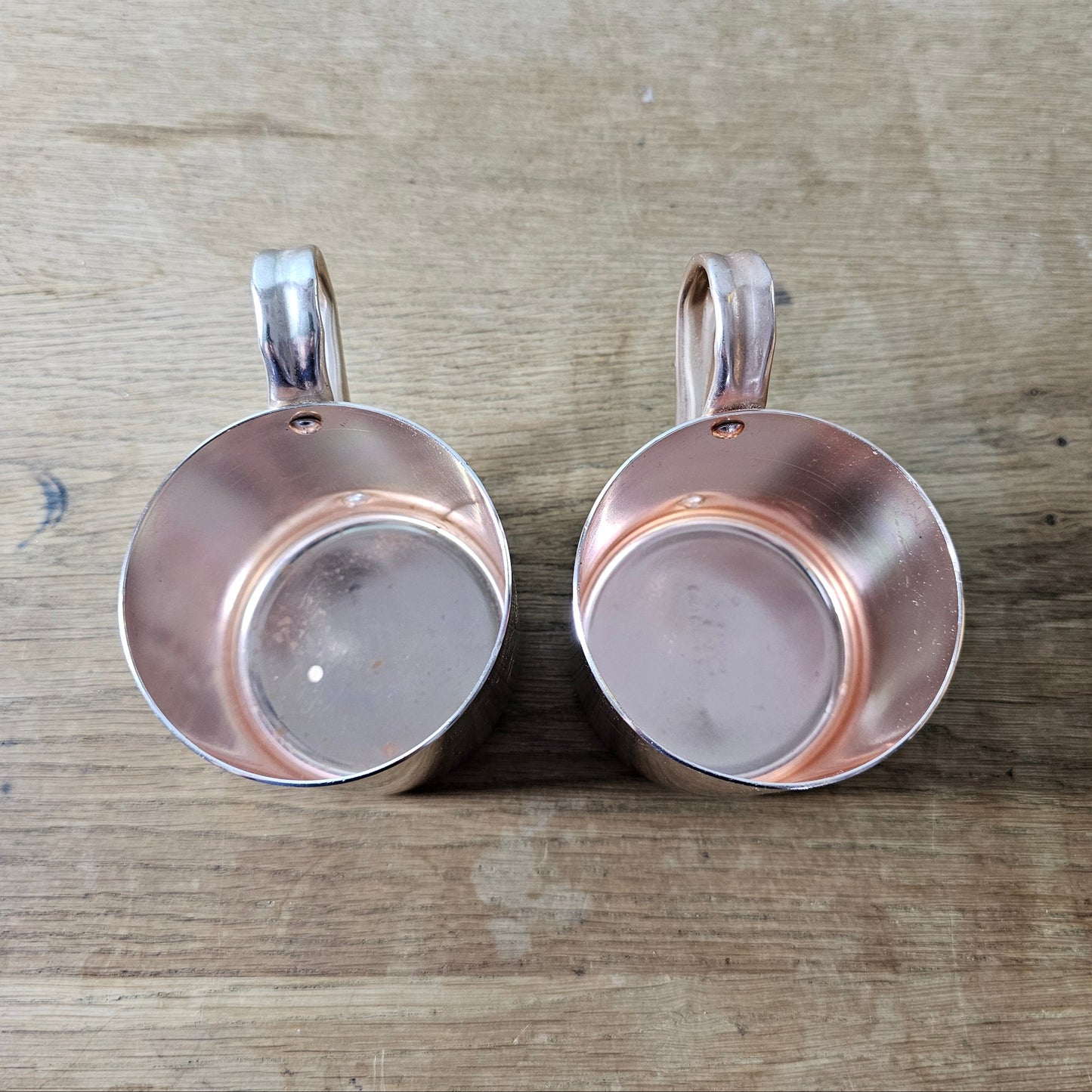 Pair of vintage Smirnoff rose-gold & copper mule mugs