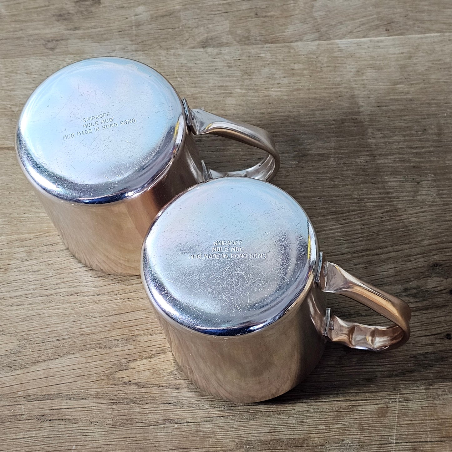 Pair of vintage Smirnoff rose-gold & copper mule mugs