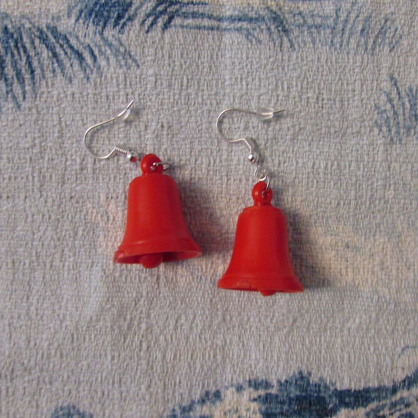 Kitsch home-made earrings made using vintage plastic bell cake toppers